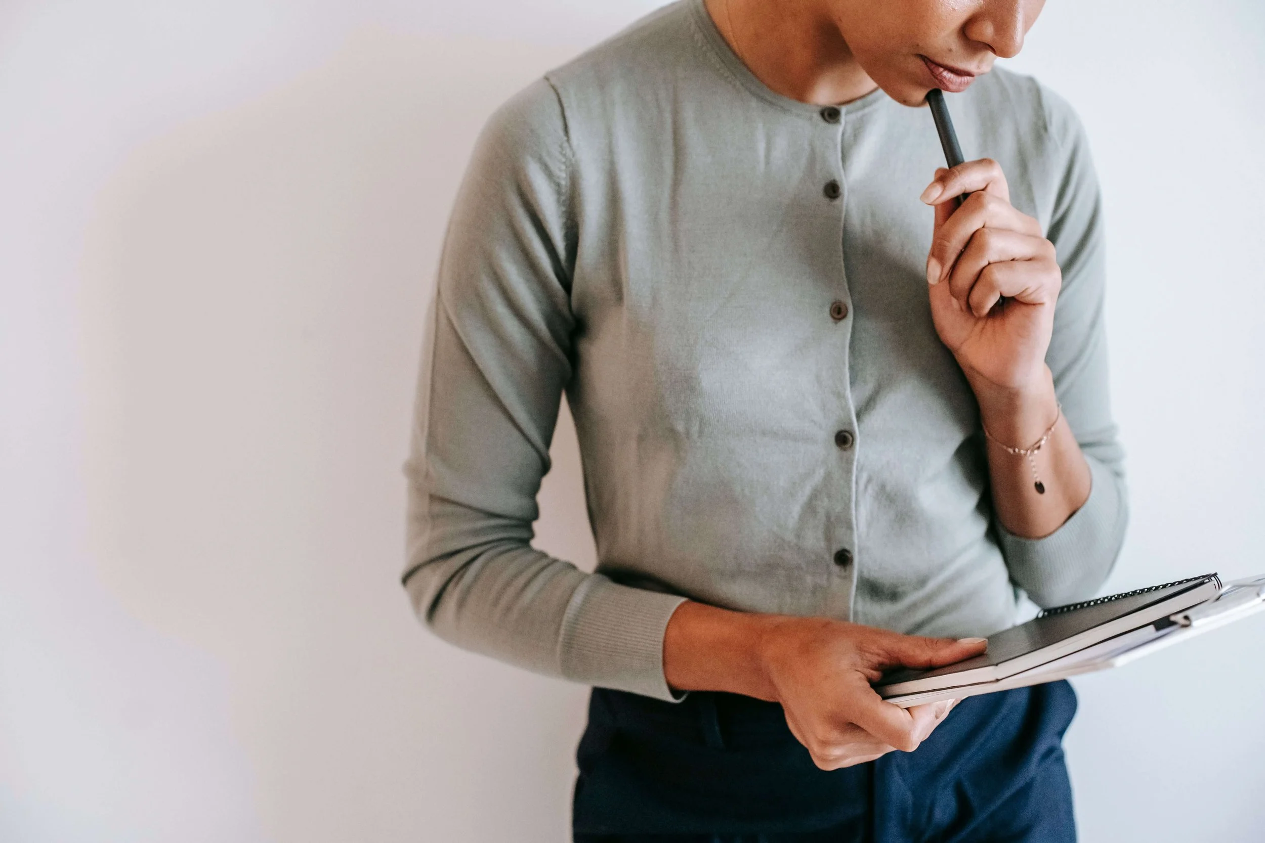Close-up of a woman deep in thought, illustrating self-discovery and emotional processing supported through trauma therapy for young adults in Manhattan.