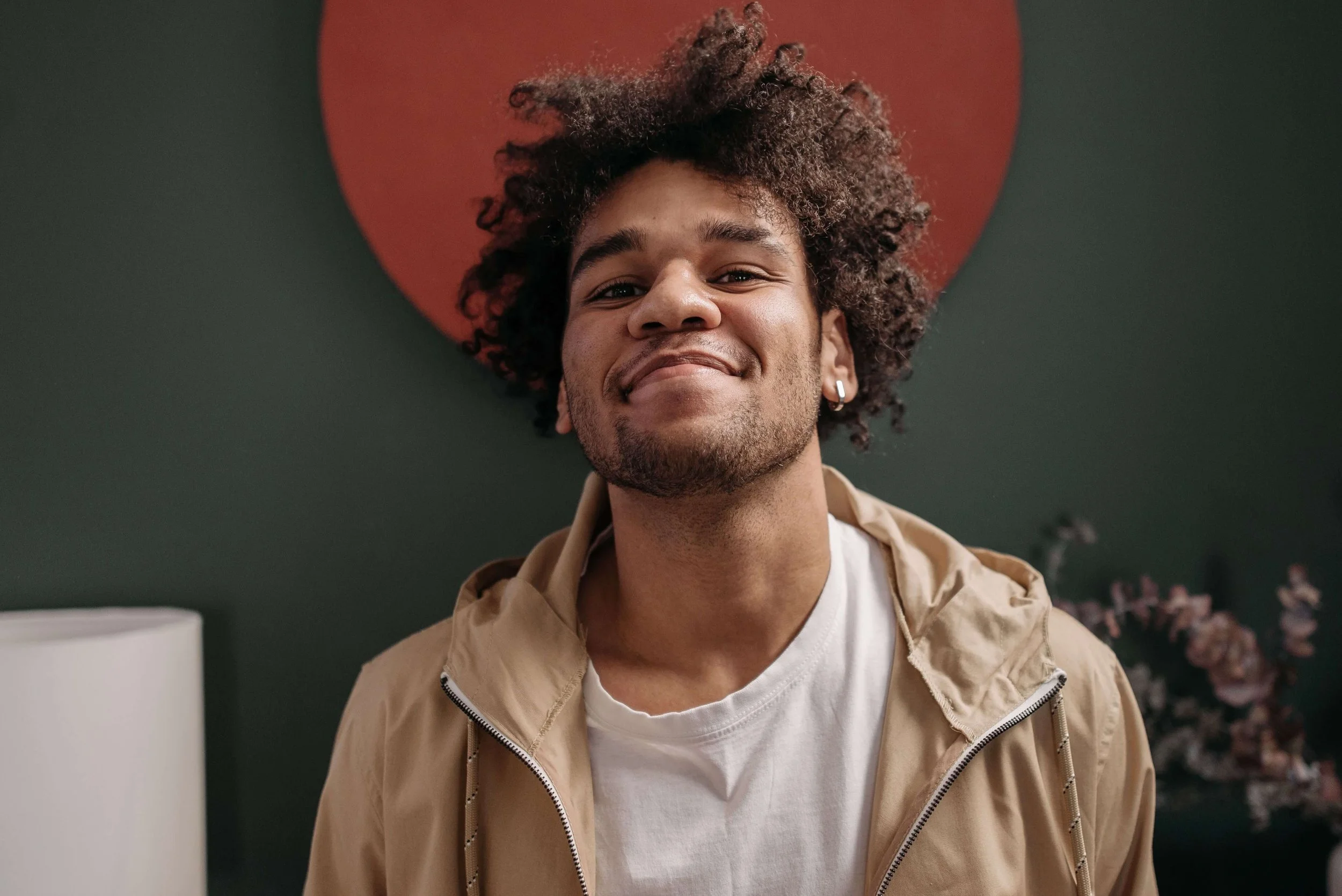 Smiling young adult man representing greater confidence, self-acceptance, and progress supported through perfectionism therapy in New York.