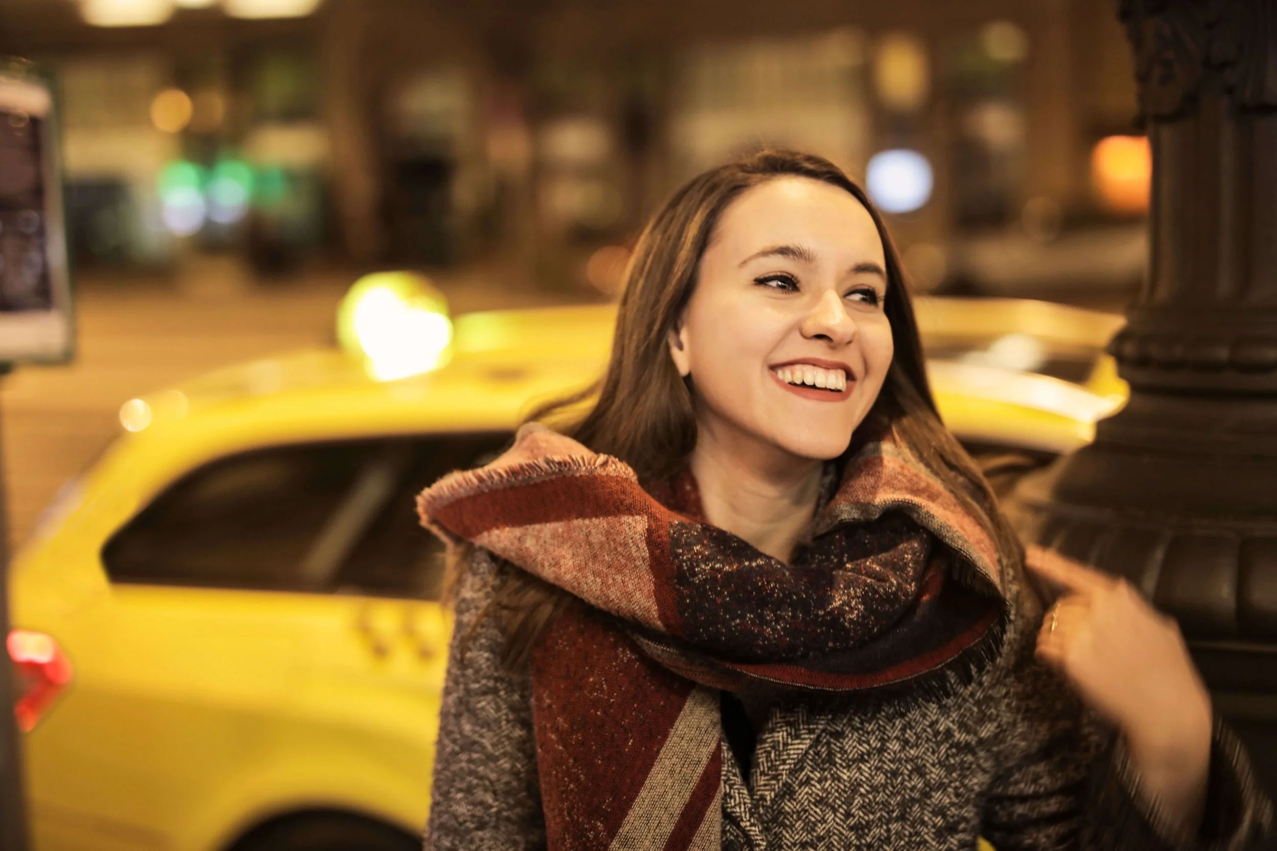 Smiling woman outdoors in NYC, representing renewed confidence, personal growth, and emotional healing supported through trauma therapy for young adults in Manhattan.