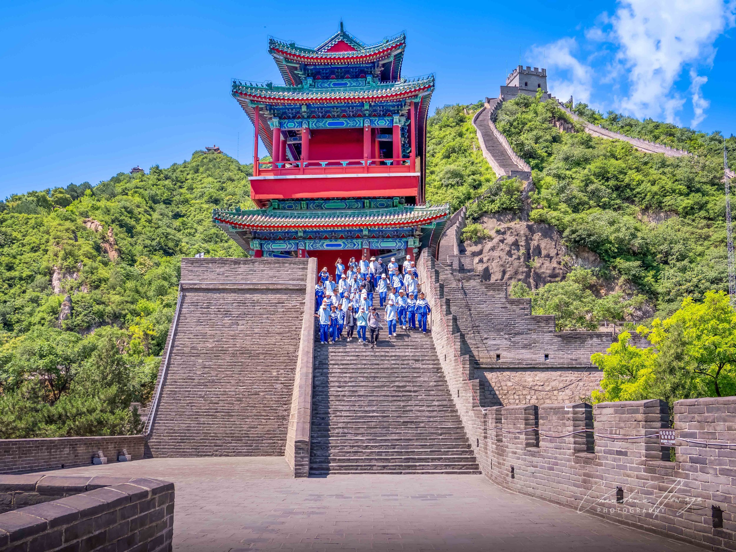 The GRAND YINGKOU TOWER ("Welcoming Guests Tower"). It stands at the base of the steep mountain loop where hikers begin and end their grueling climbs.
This is a premium, multi-tiered traditional Chinese pavilion. The staircase leads to the lower sect