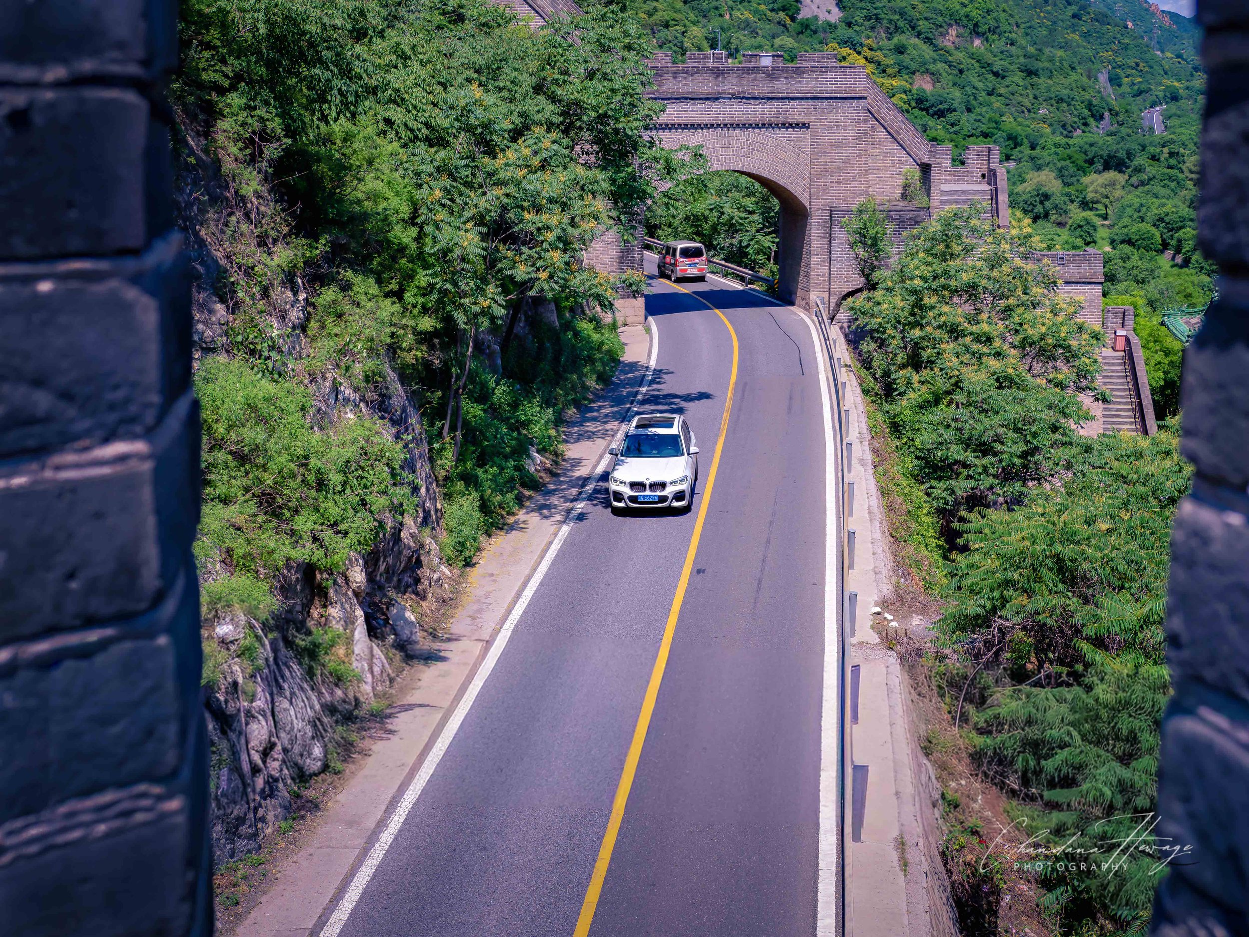 A view from above. A highway runs through the Great Wall.