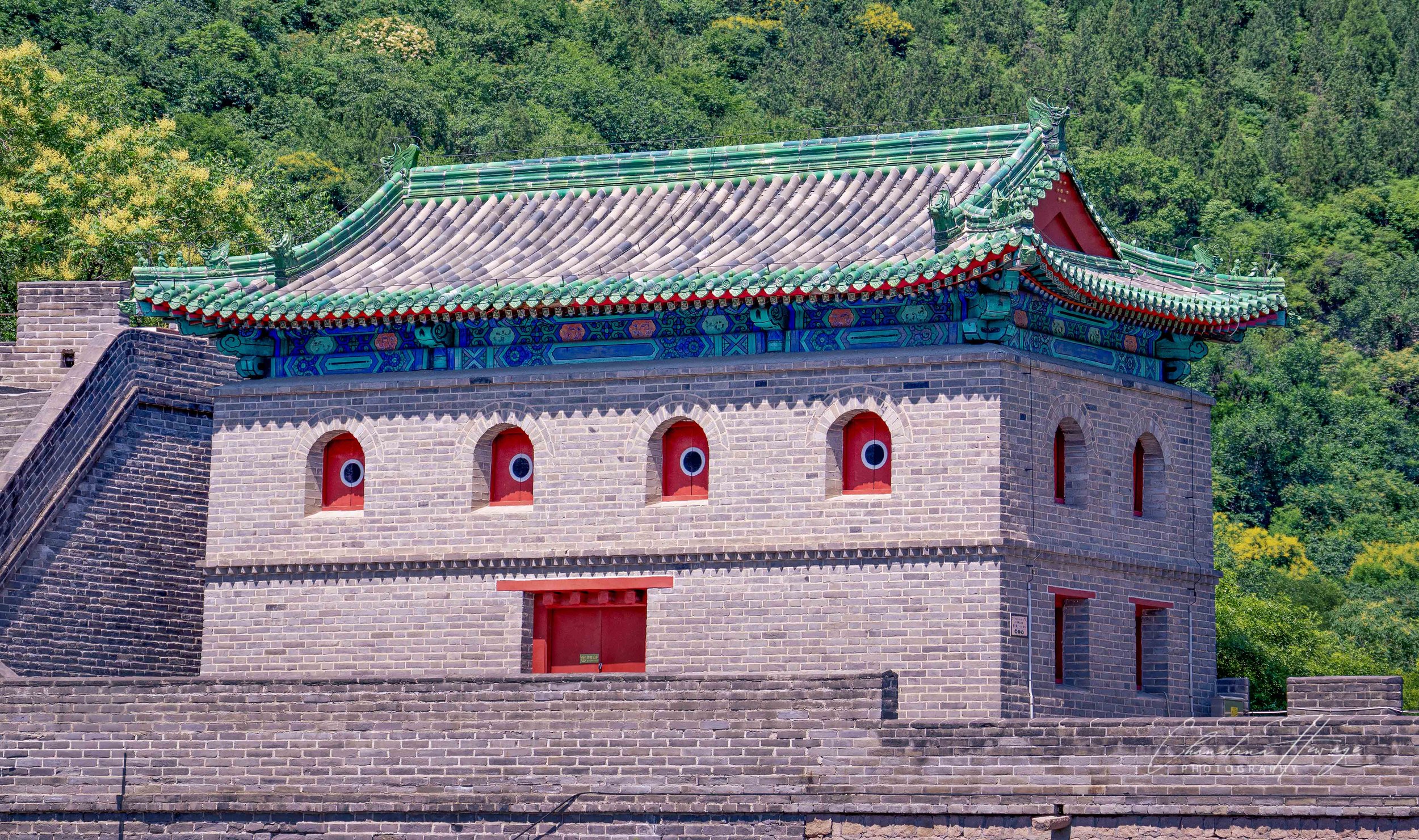 Beautiful architecture.
This features one of the heavily fortified gatehouses at the Juyongguan Great Wall loop, specifically the ZHAIDONG TOWER/ North Gatehouse complex. 
The most striking feature is the row of "Bullseye" Arrow Slits.
This is a clas