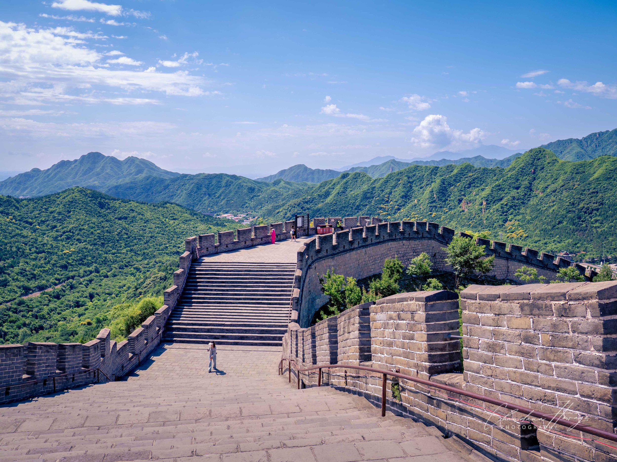A part of a wide, sweeping stone platform and a massive staircase. 
This was engineered specifically to accommodate 5 horses or 10 soldiers marching abreast. 
The Double-Sided Battlements: Both the inner and the outer sides of the wall feature high d