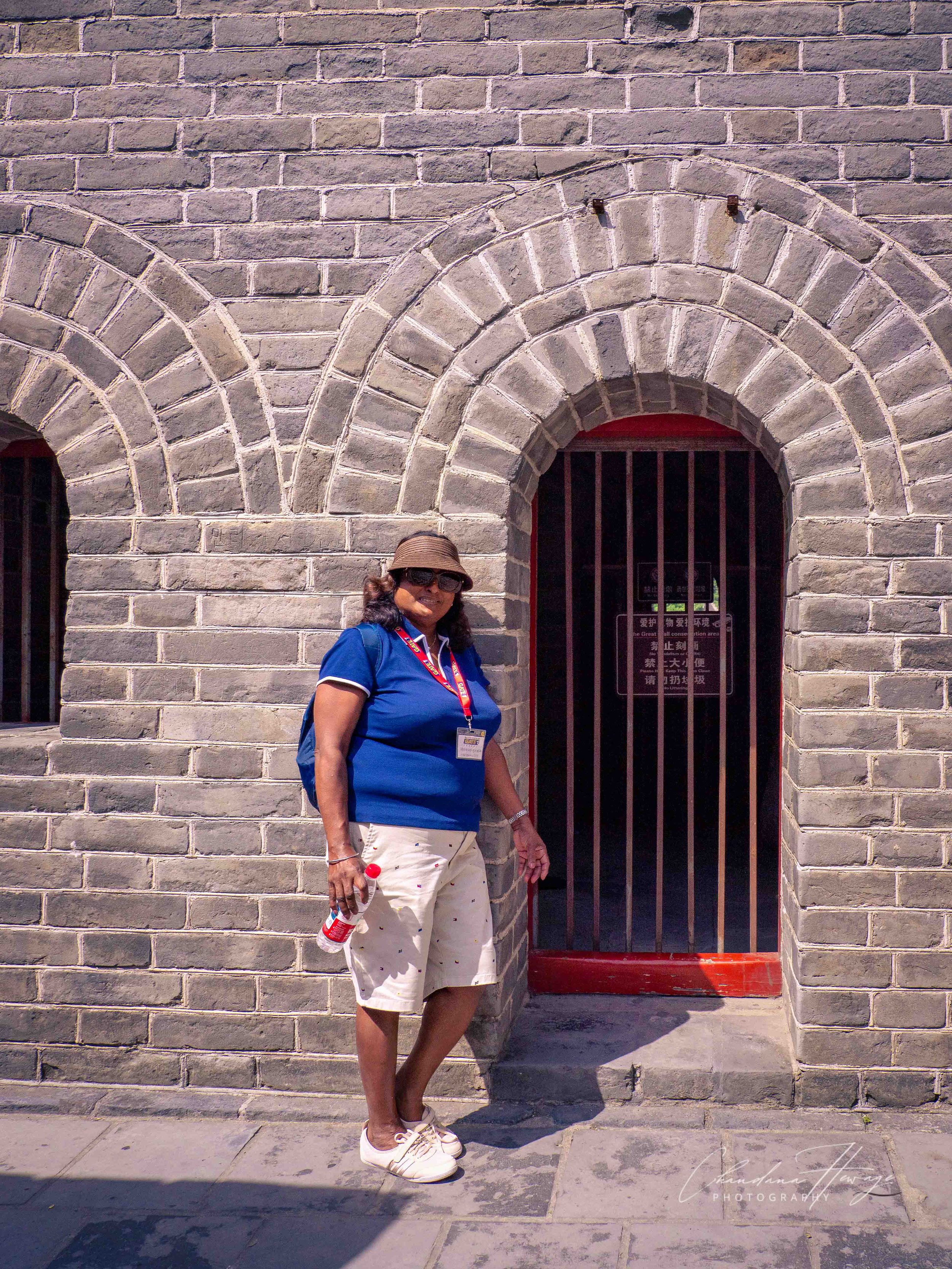 Nali is posing at a barred arched doorway of a watchtower.
These openings provided access to internal staircases, arrow repositories, or lower garrison quarters.