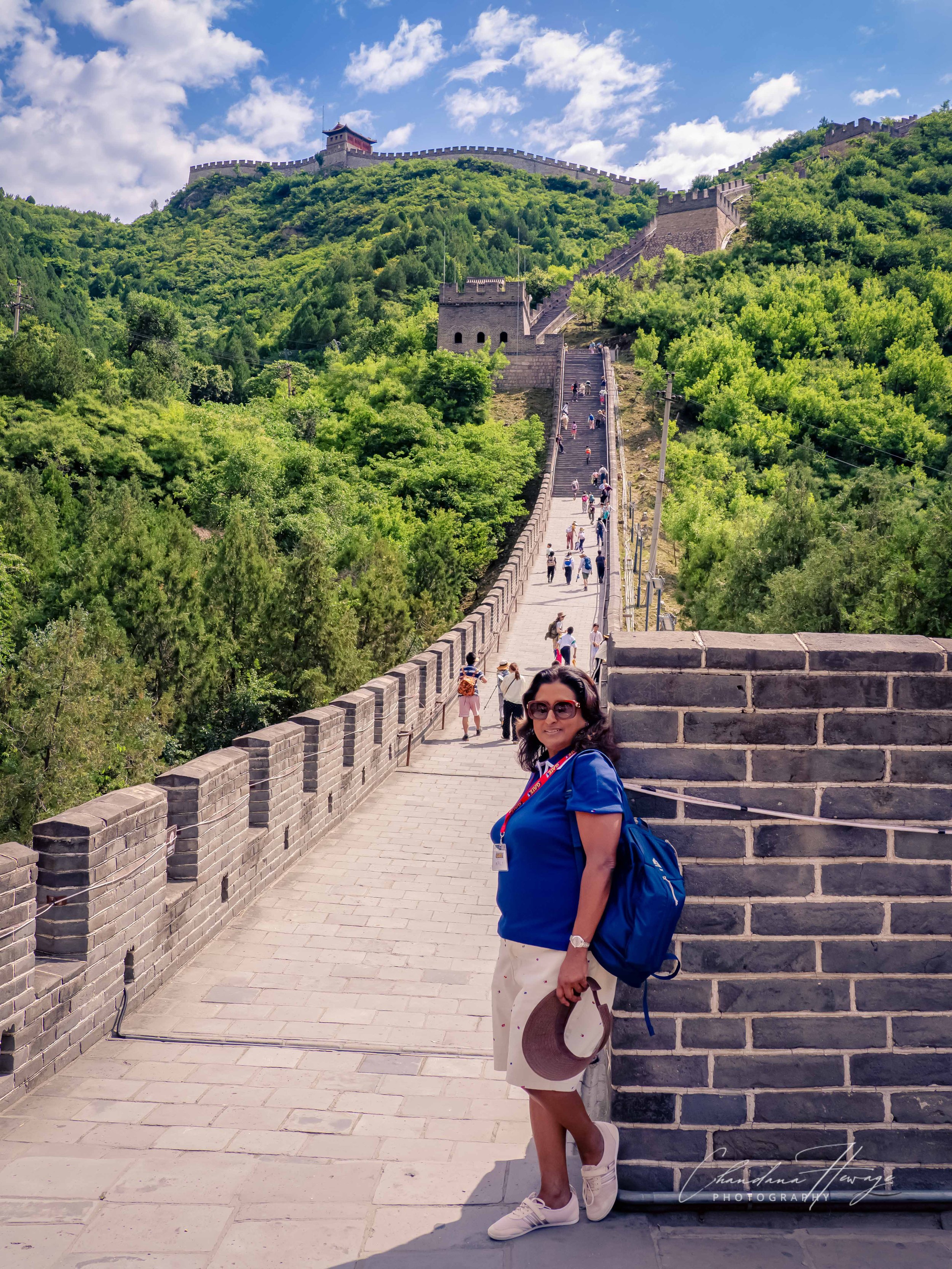 Nali is approaching the square, gray-brick watchtower No 11, directly at the top of this first steep staircase segment.
The watchtower features the characteristic arched window openings used by the Ming Dynasty guards.
