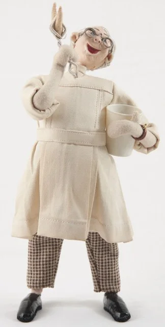 One in a series of felt medical dolls manufactured by the Klumpe Company in Barcelona, Spain. This particular doll comes from the 1950s and depicts a dentist triumphantly holding up an extracted tooth (Accession Number 009013001).