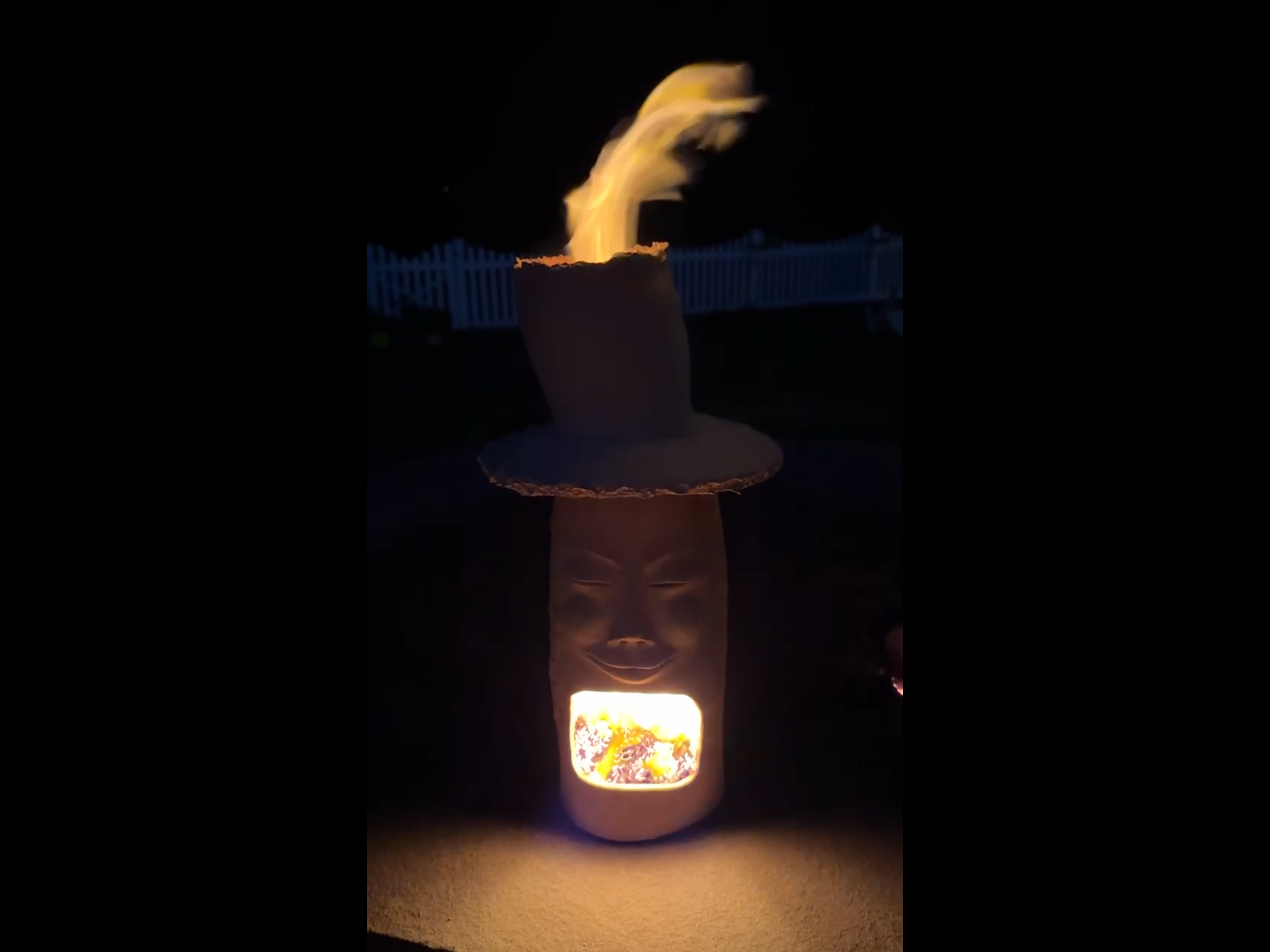 The first firing.  I expected smoke but not flame from the hat.  I was also surprised and excited to see the firelight on the surface in front of the sculpture.