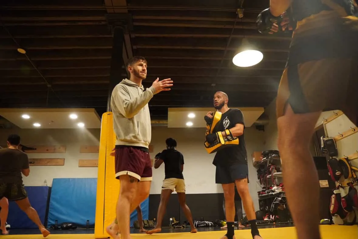 Coach Ben gives instruction during a group class at Broad Street Kickboxing.