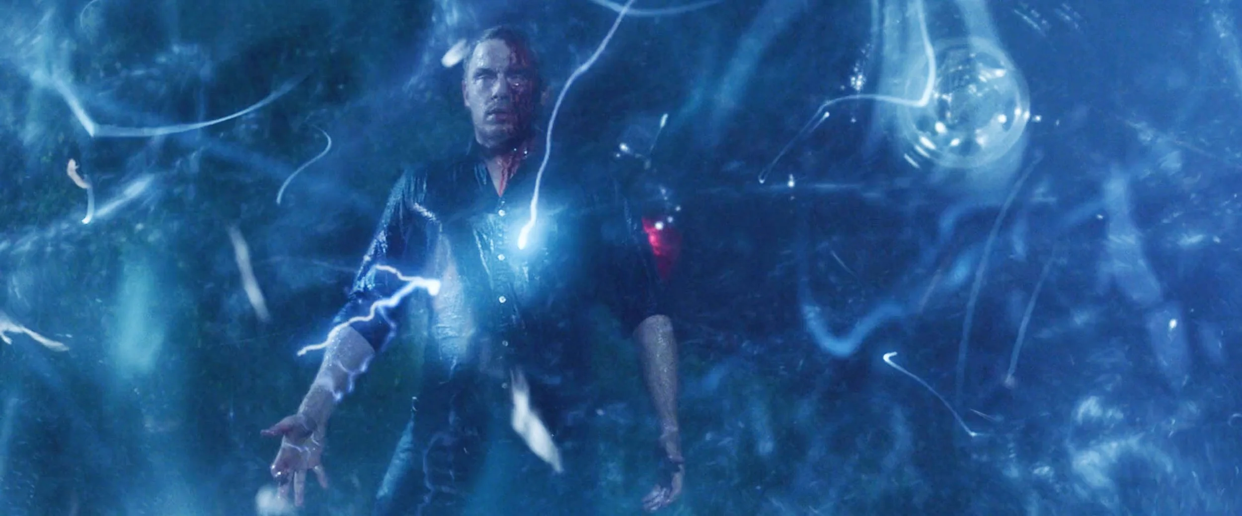 A person standing inside a blue, swirling energy field with lightning-like streaks and abstract patterns.