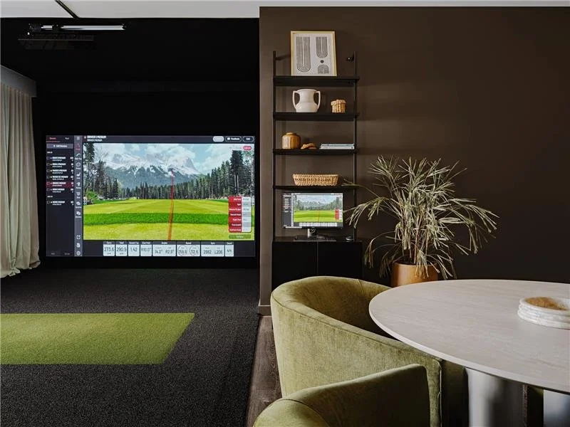 Golf simulator space inside multi-family residential building