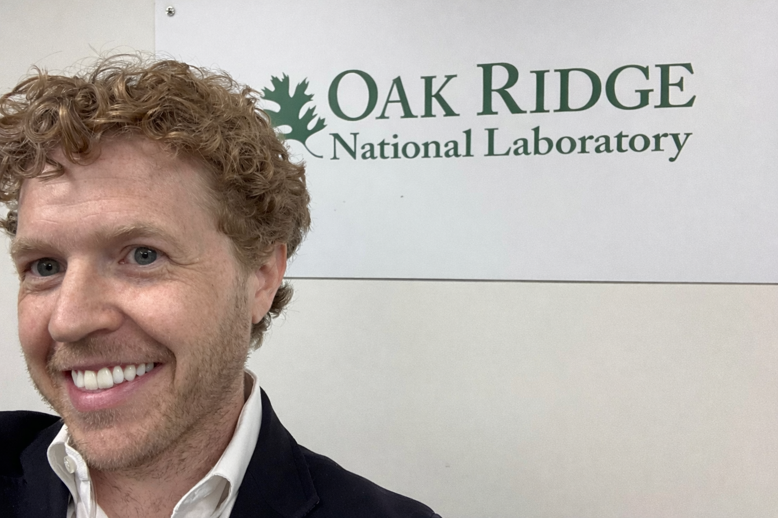 Owner of IRIS7, RZFeeser in front of a sign for Oak Ridge National Laboratory.