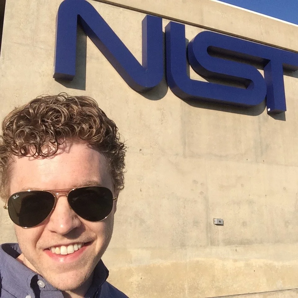 Owner of IRIS7, RZFeeser wearing sunglasses and a collared shirt, in front of NIST labs.