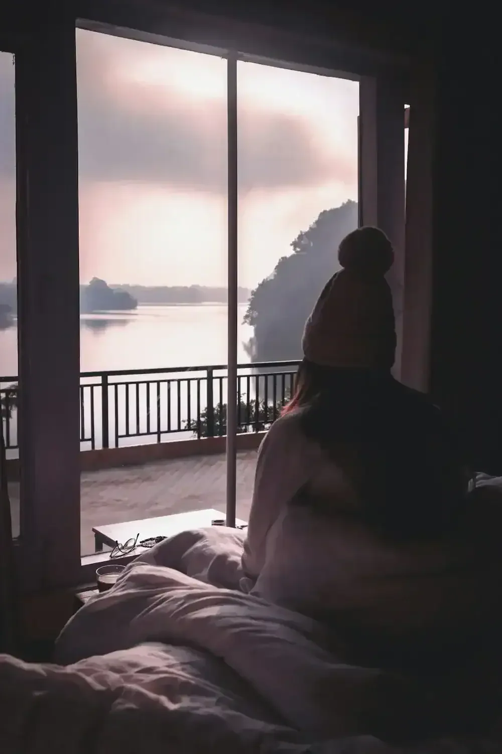 person looking outside a window at a beautiful landscape
