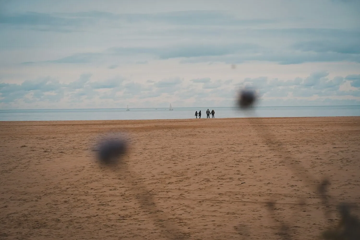 group of people on a beach in the distance