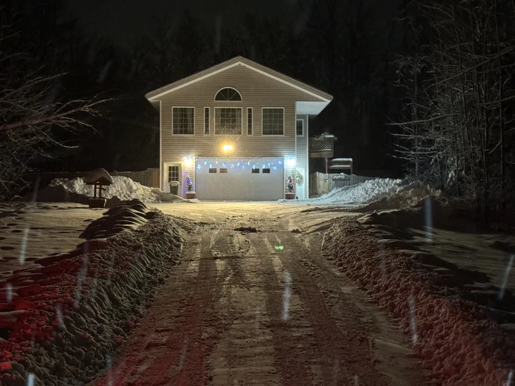 Ten-foot snow piles beside a two-story Wasilla home