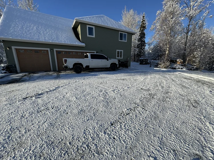 Large residential plowed property with a Snip&Clip Alaska truck