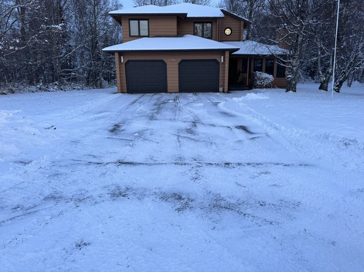 Cleared driveway at an orange house in Palmer