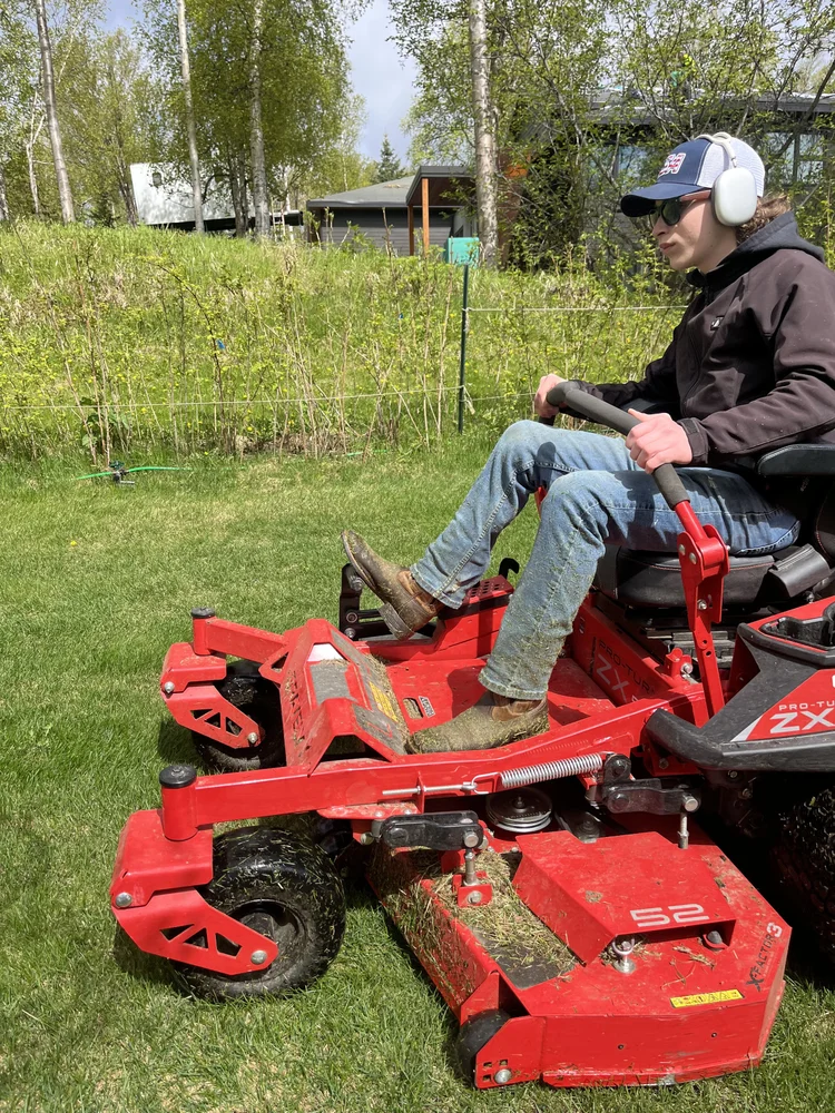 Crew member mowing in Wasilla