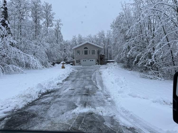 Cleanly scraped plowed driveway in Wasilla