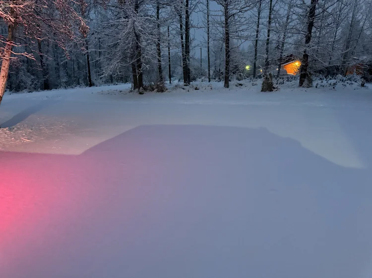 Residential driveway full of snow before plowing