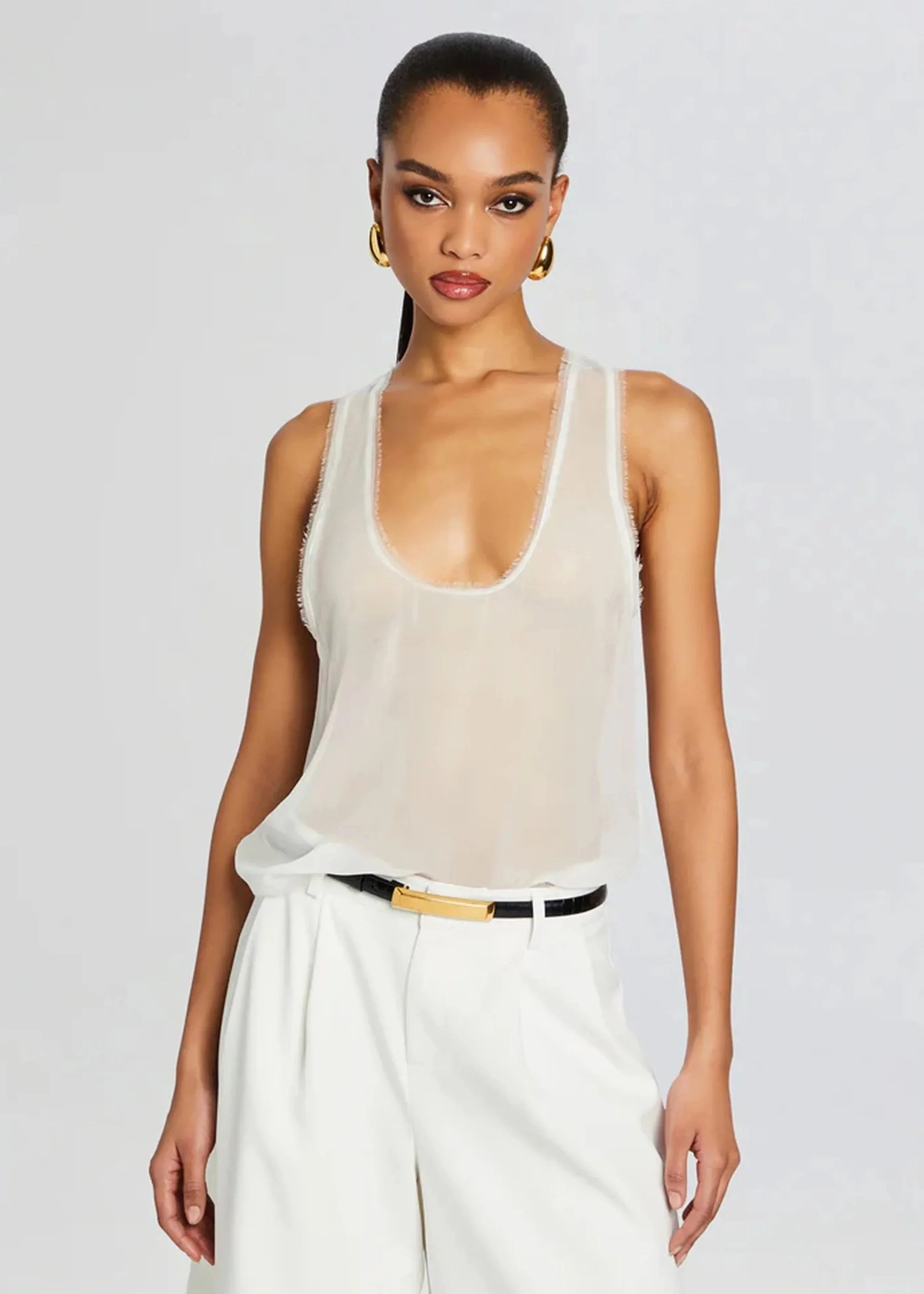 white tank top and white trousers