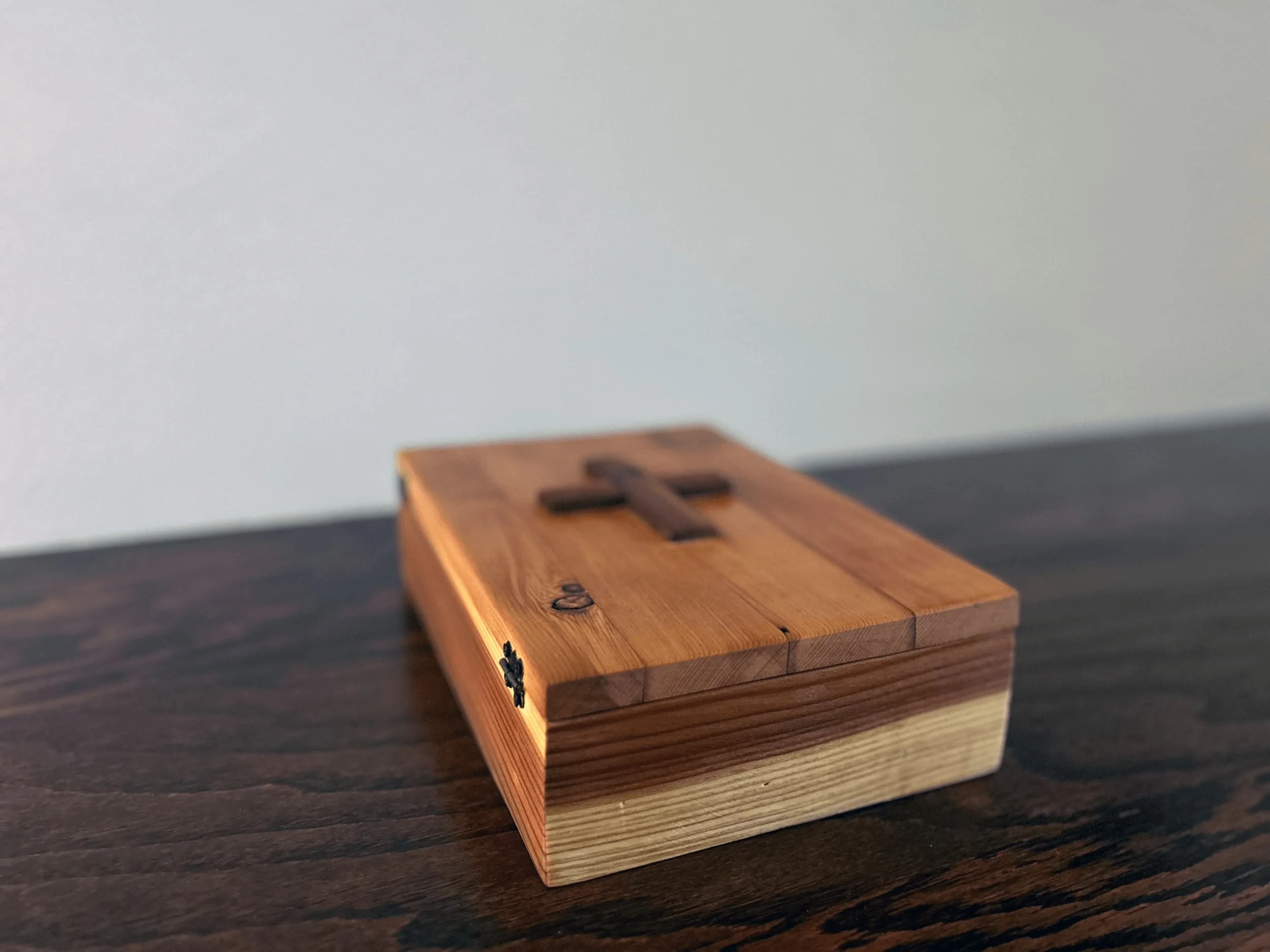 handcrafted wooden Bible box with carved cross on lid and contrasting wood tones