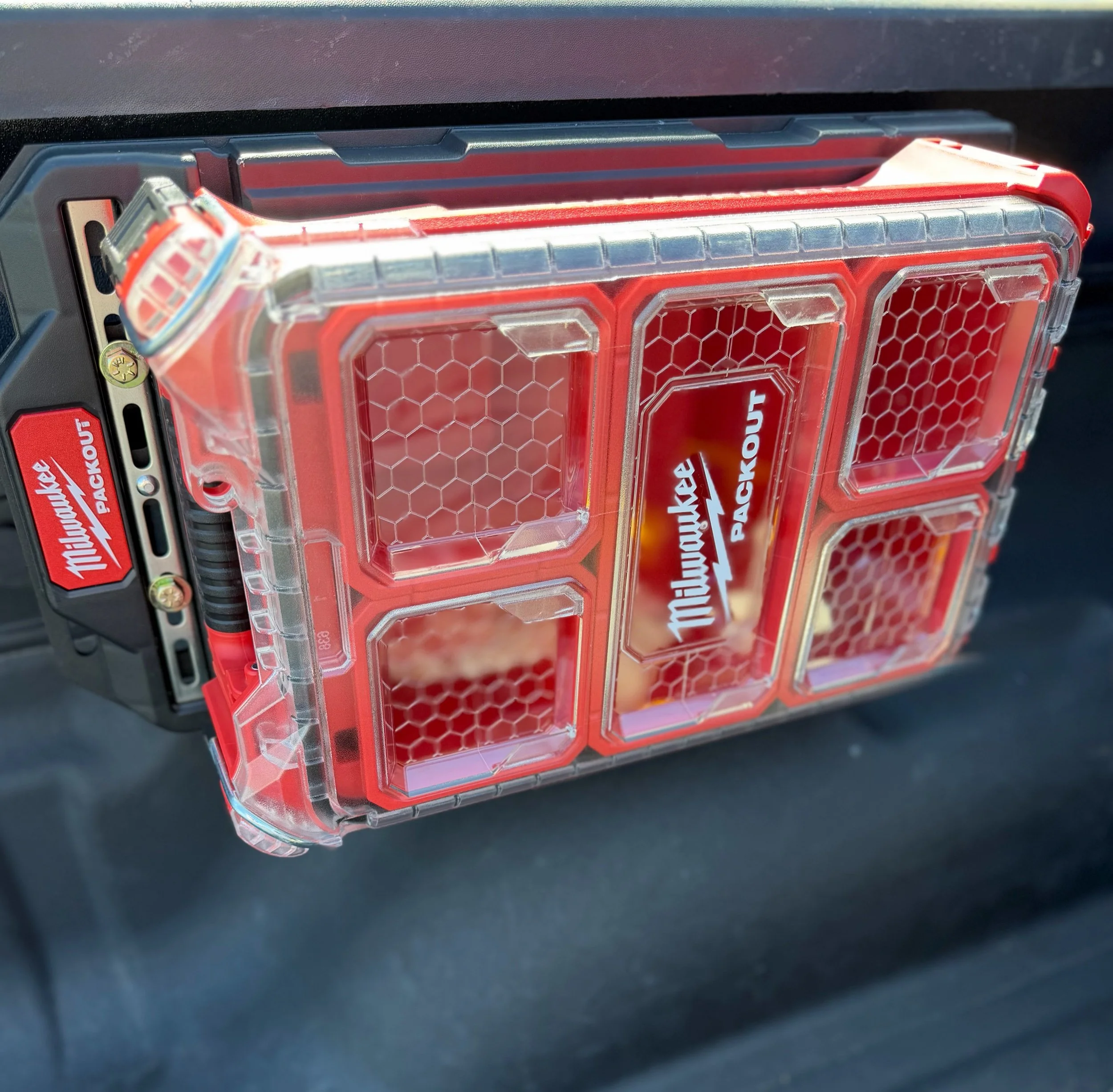 Baja Ram Runs Molle Panel Bed Rail System supporting a Milwaukee Packout organizer in the bed of a Ram 1500.