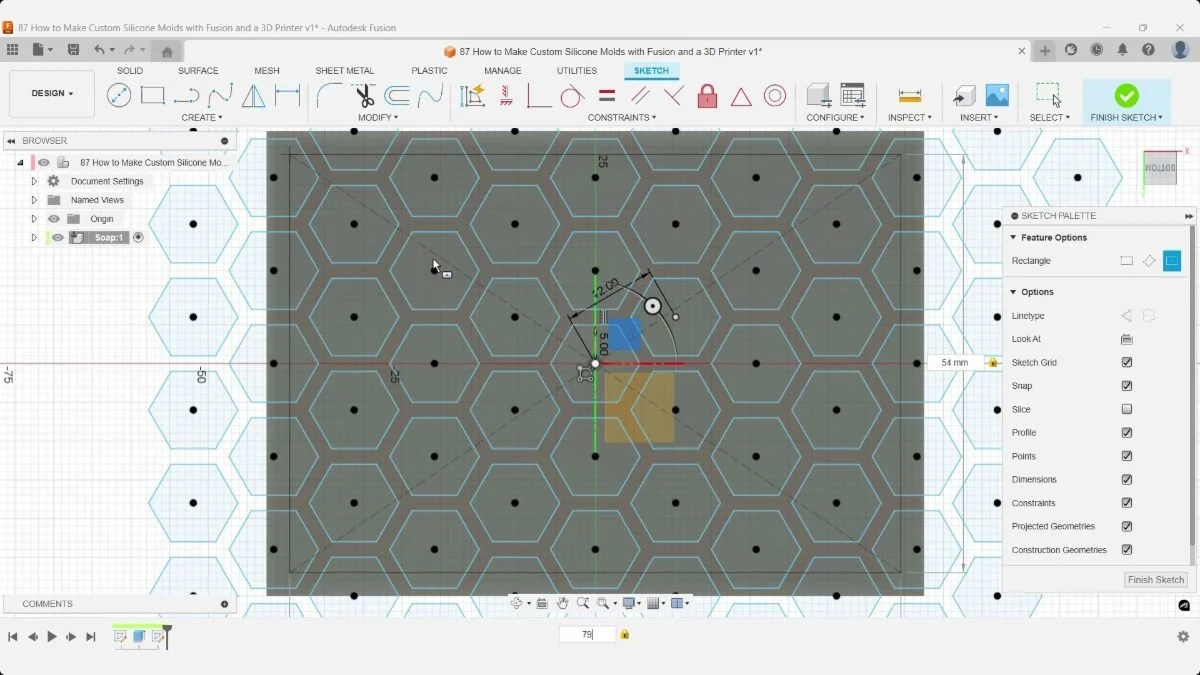 A centered border rectangle being dimensioned across the honeycomb soap sketch in Fusion.