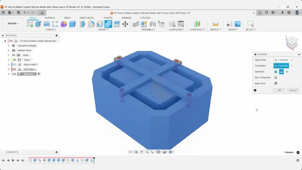 Fusion Combine preview highlights the mold base and four alignment pins at the support ends.