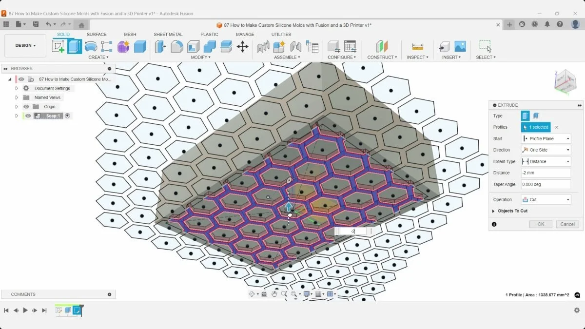 Honeycomb sketch regions highlighted on the underside of the soap during an Extrude operation in Fusion.