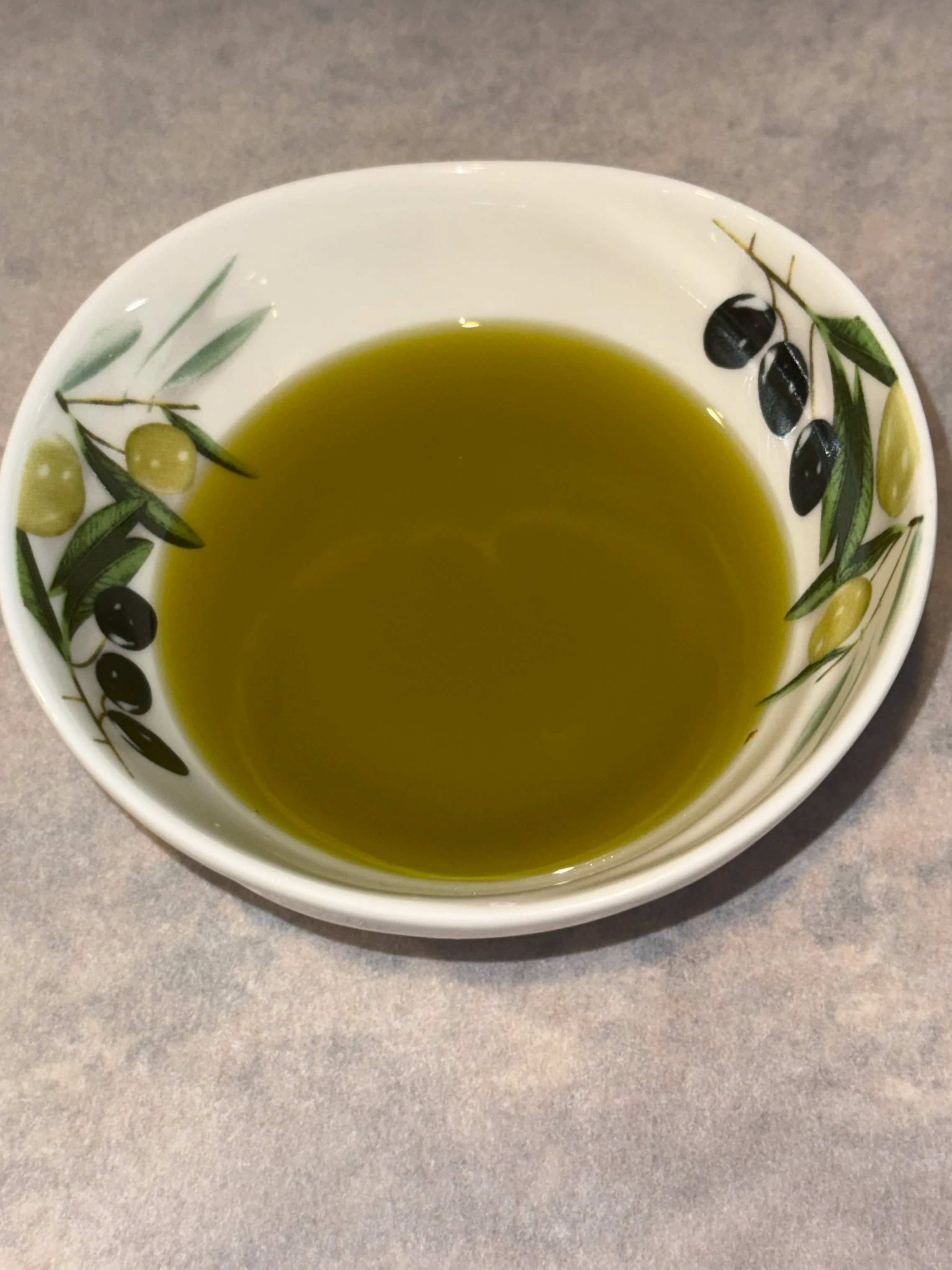 Close‑up of Ygeia’s cold‑extracted extra virgin olive oil in a dipping bowl.
