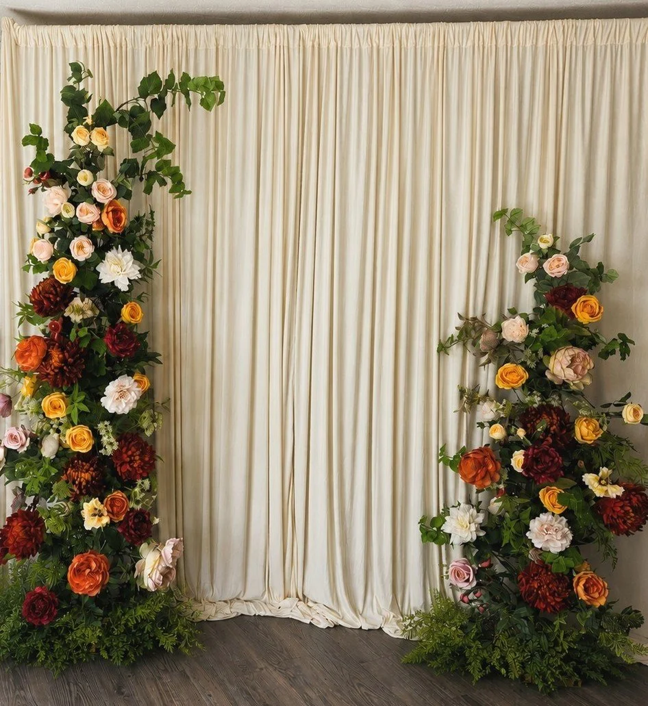 Floral backdrop hire in Edinburgh with sculptural faux flowers and an ivory fabric backdrop for events and celebrations.