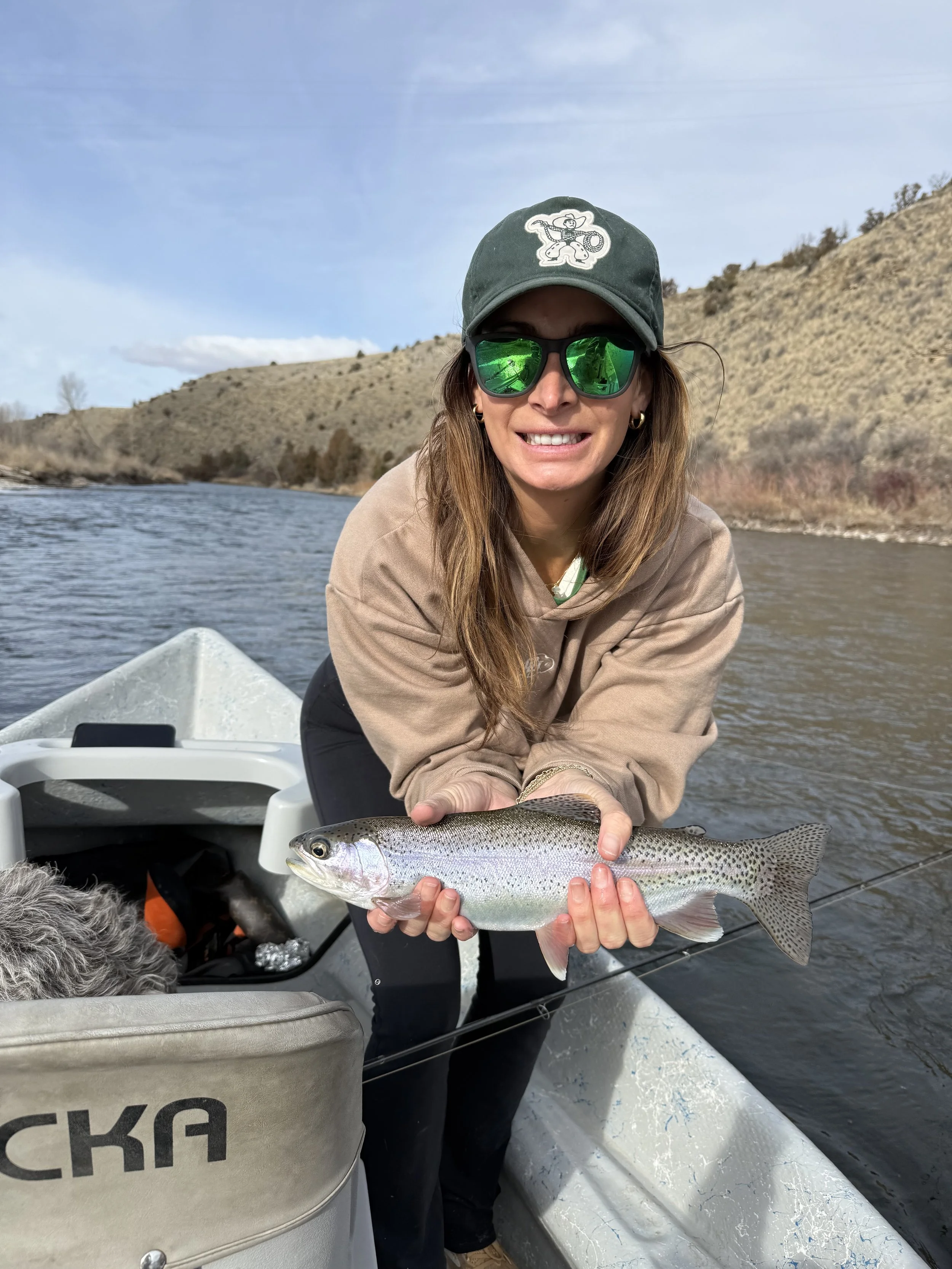 Happy client on the Gallatin River with a nice rainbow trout she caught while fly fishing.
