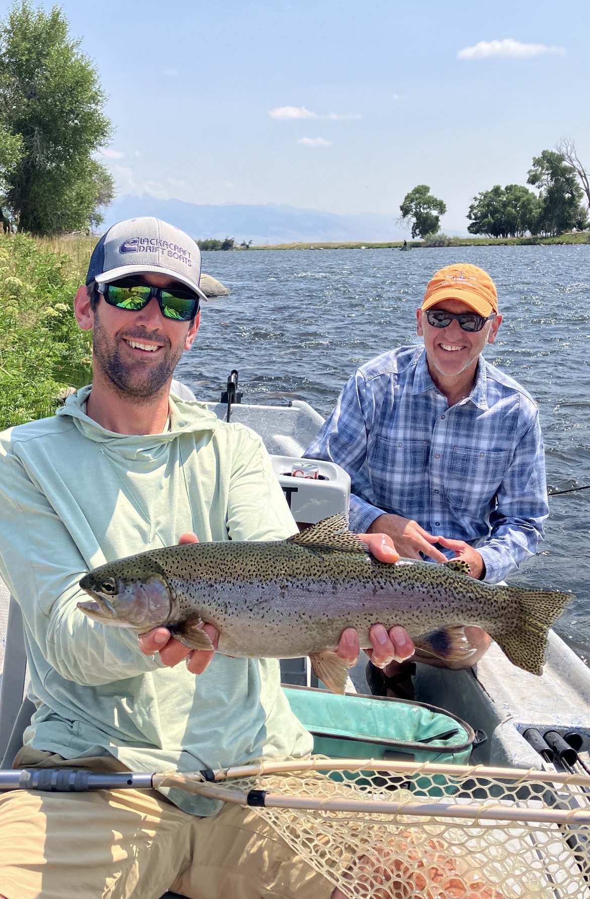 Angler holding wild rainbow trout caught on dry fly in Bozeman Montana