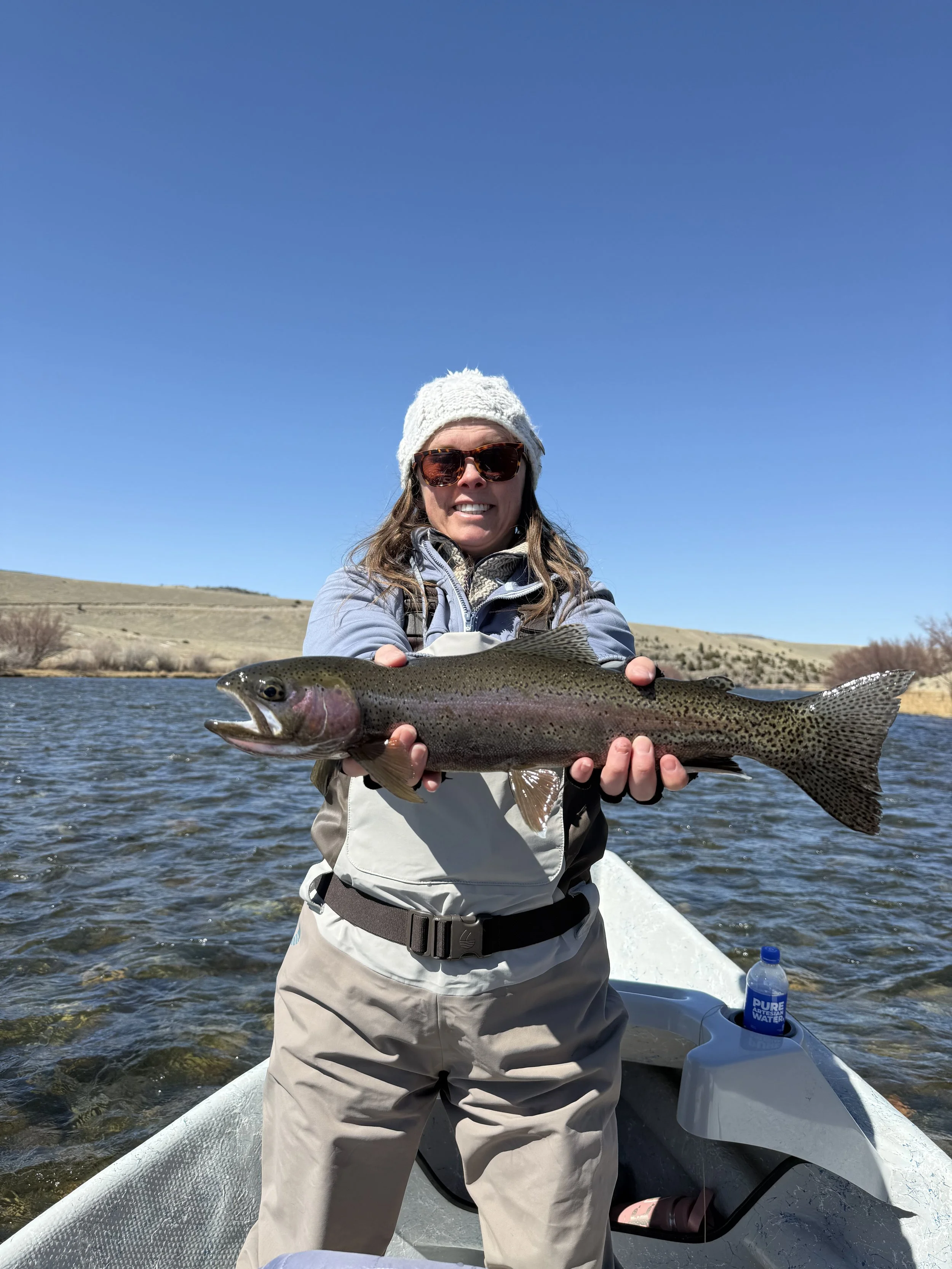 Client catching rainbow trout on the Madison River near Ennis Montana