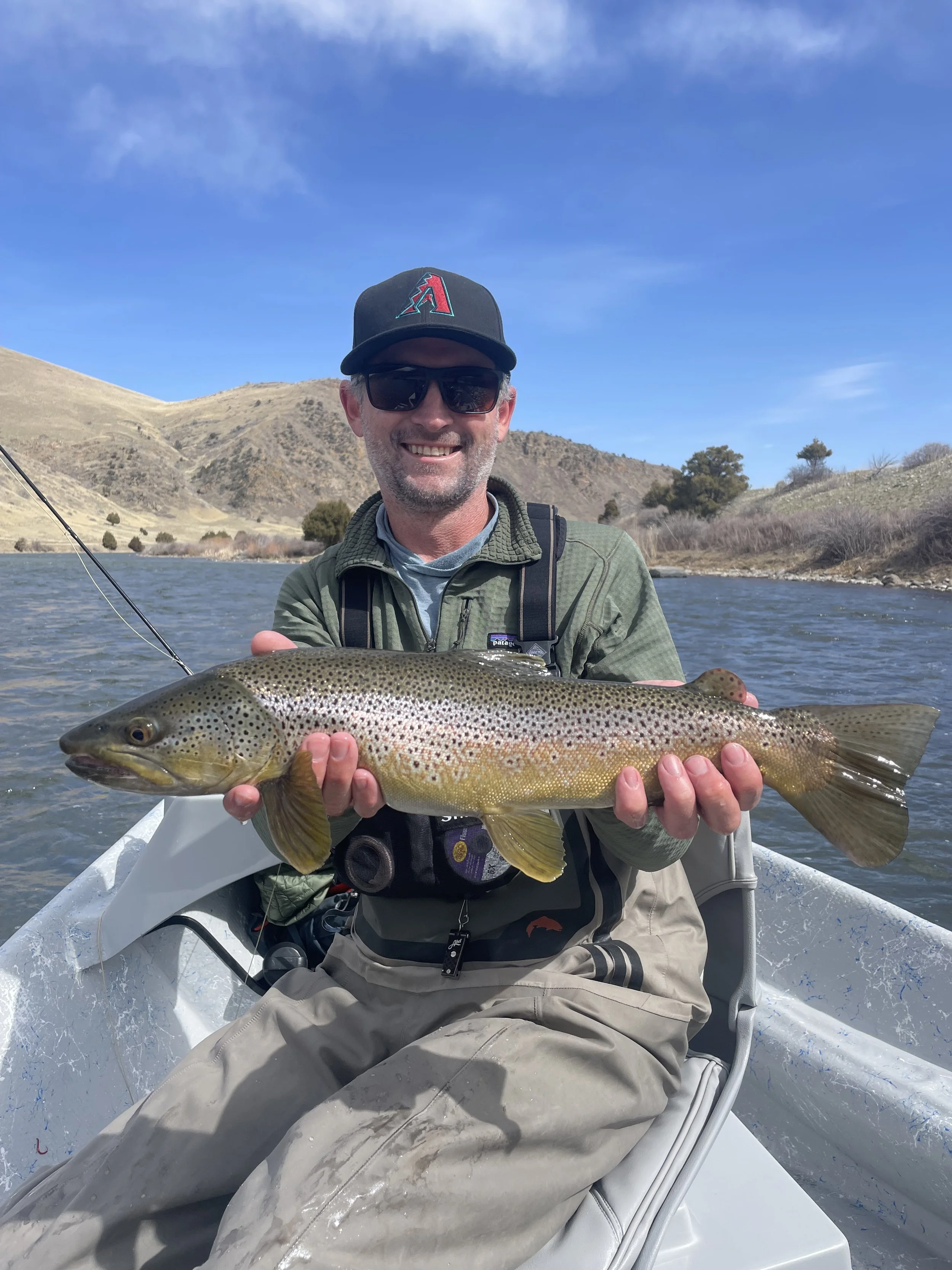 Angler holding wild trout caught on dry fly in Bozeman Montana