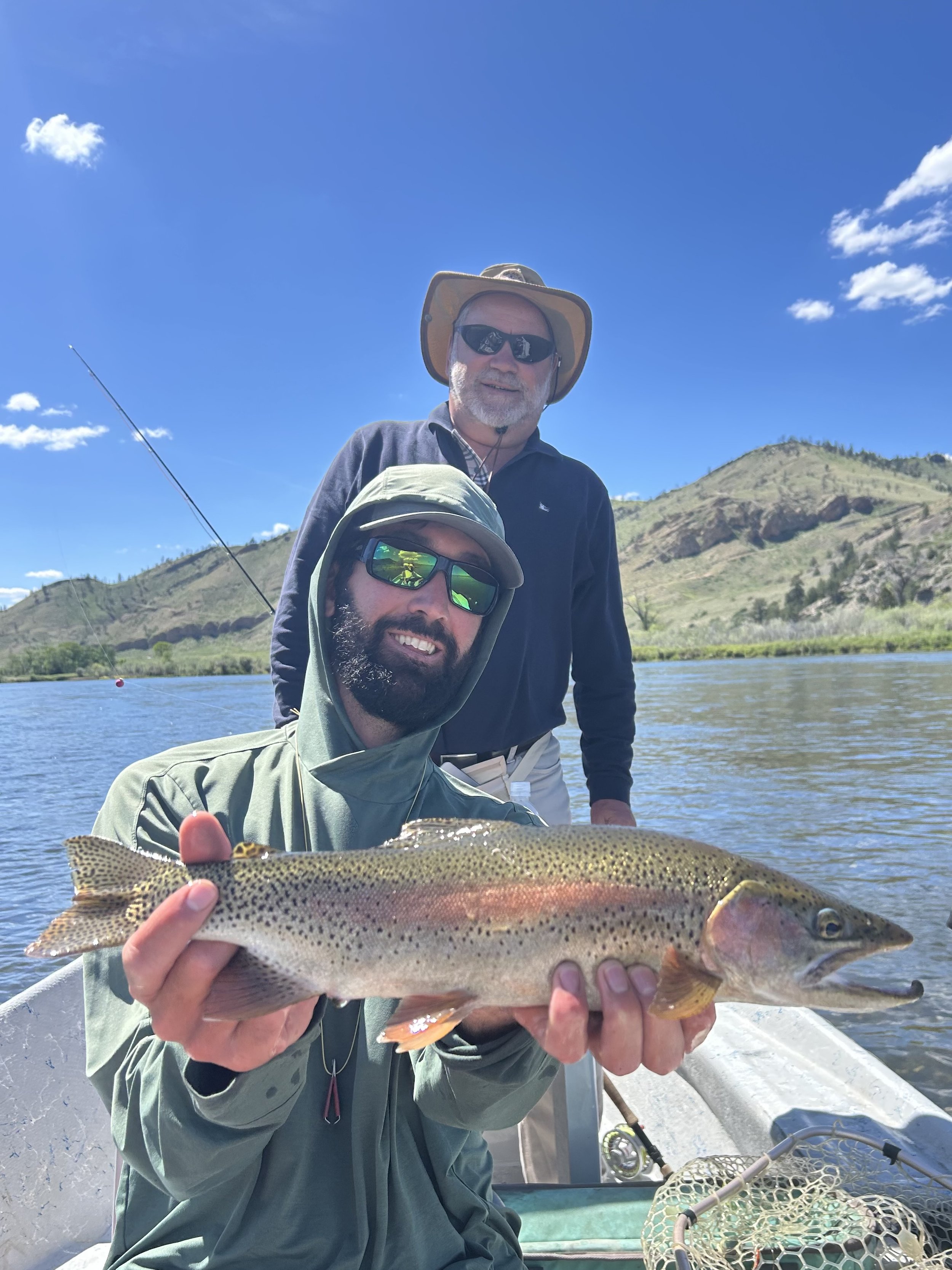 Fly fishing guide holding a rainbow trout on the missouri river. Dry fly fishing