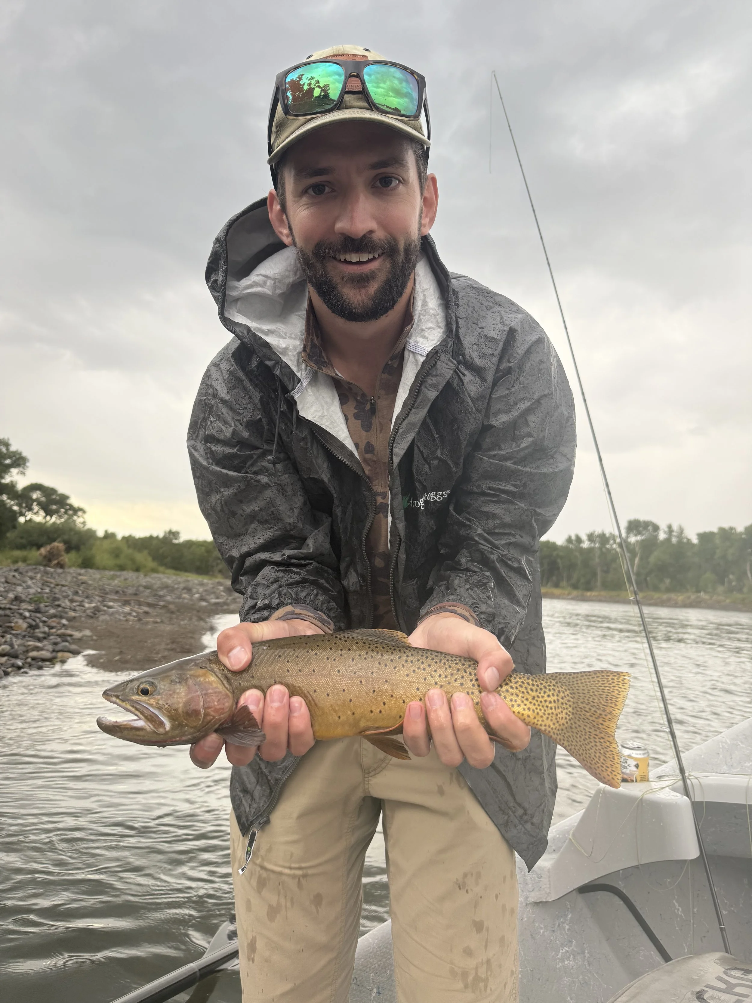Client holding cutthroat trout on the Yellowstone River