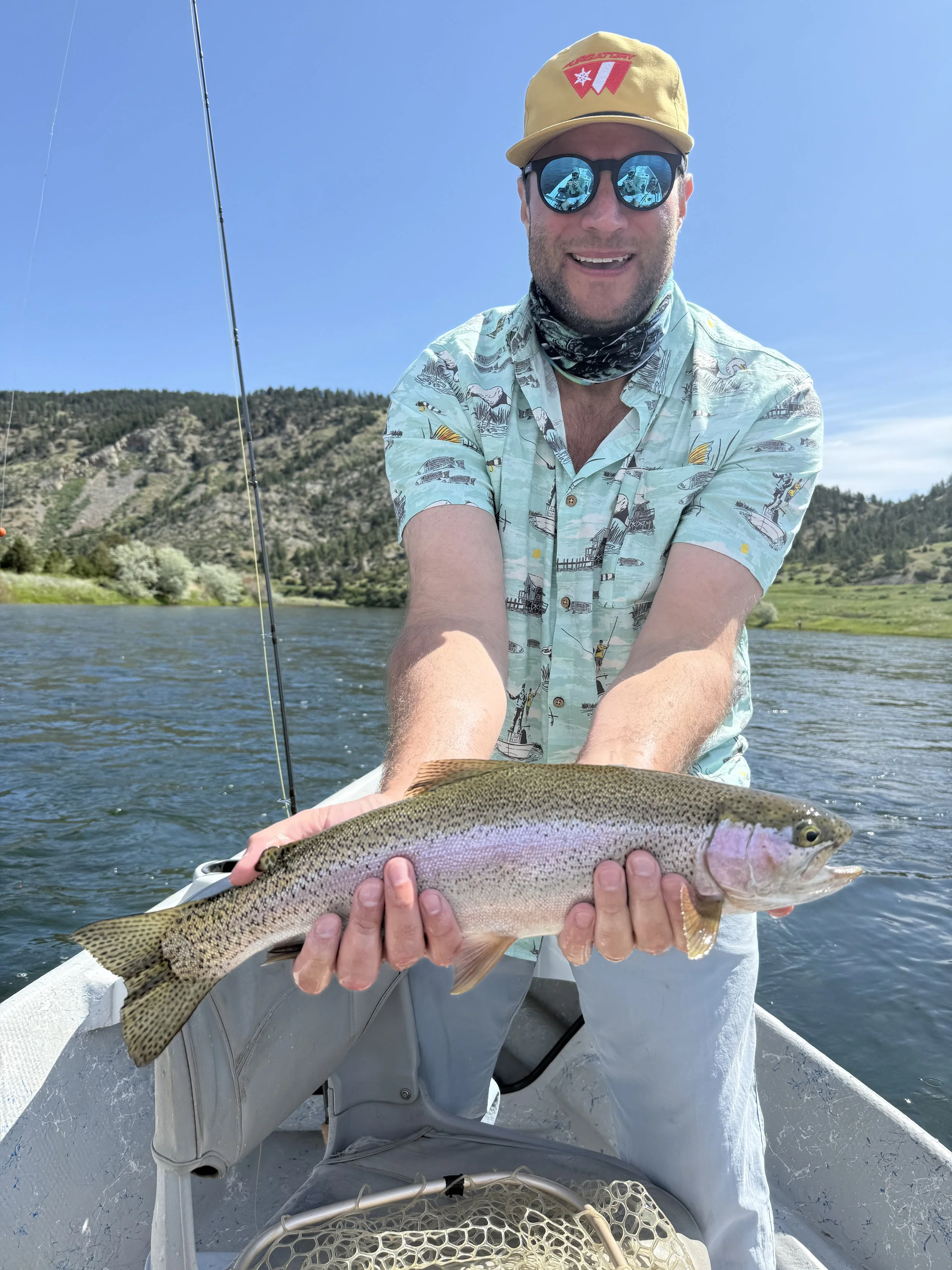 Another happy client with a big rainbow trout caught on a guided fly fishing trip in Bozeman Montana