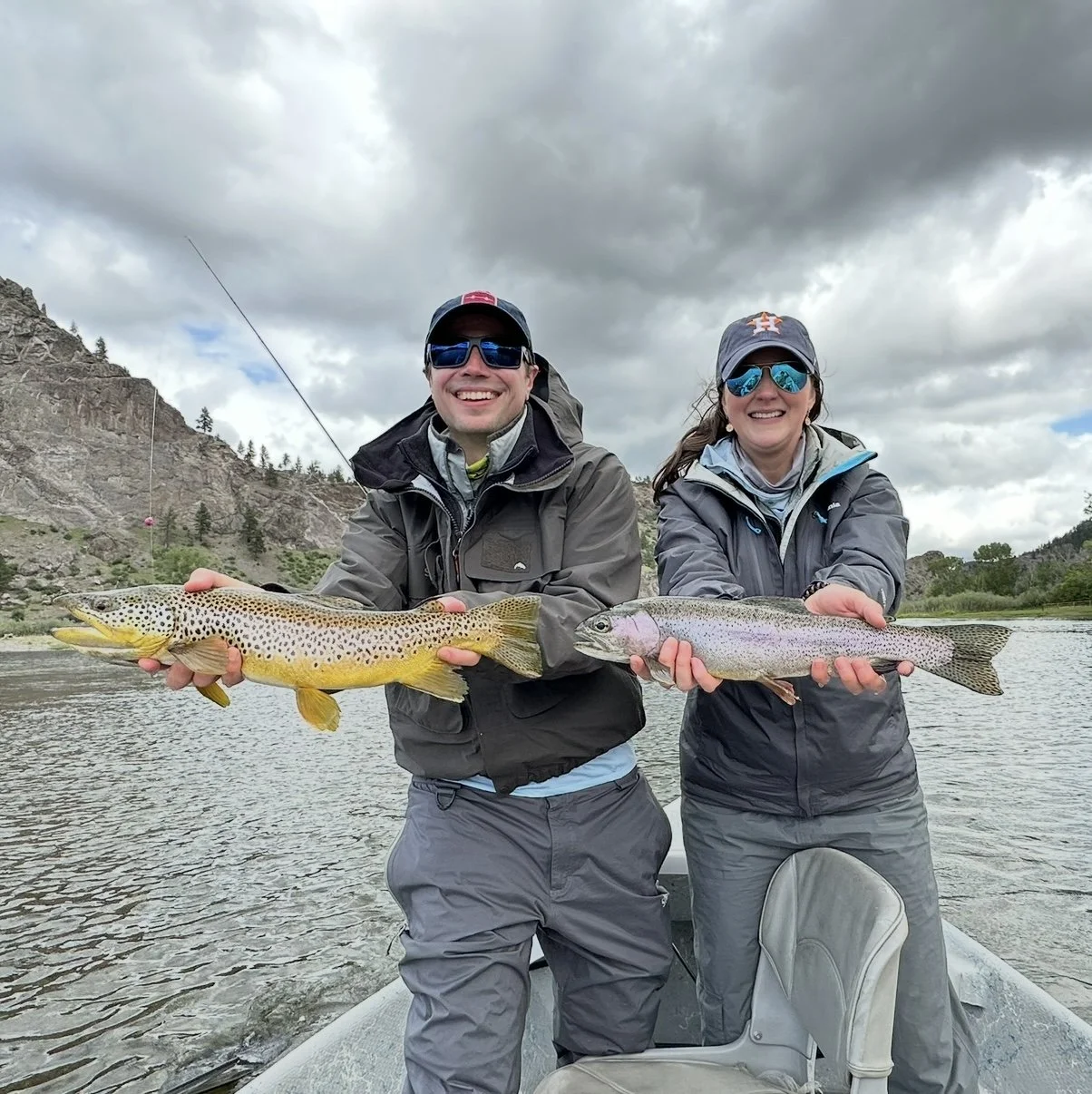 Doubled up! clients holding the fish they caught on fly rods on the Missouri River on a guided fly fishing trip in Montana