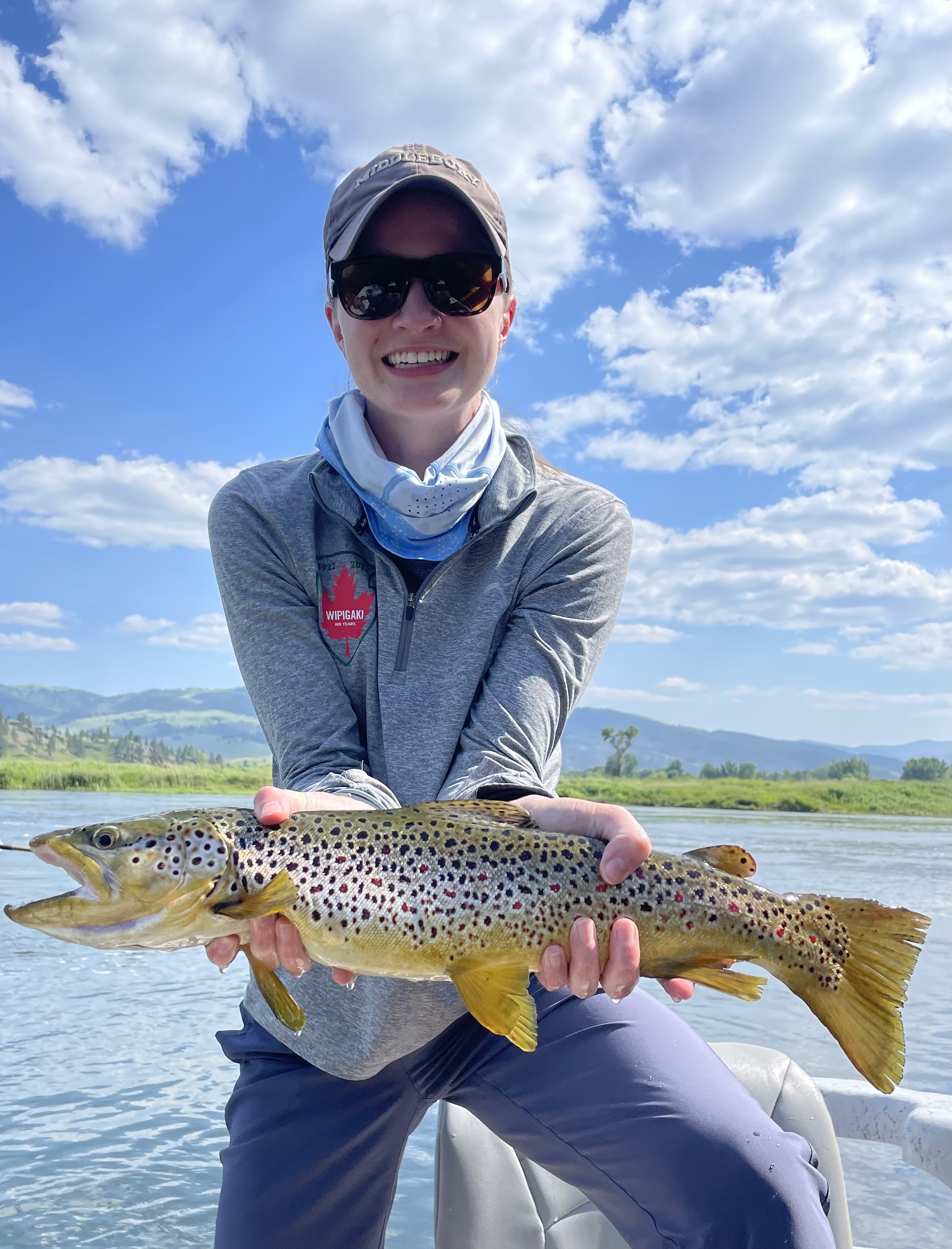 Client holding a big brown trout caught on a guided fly fishing trip on the Missouri River