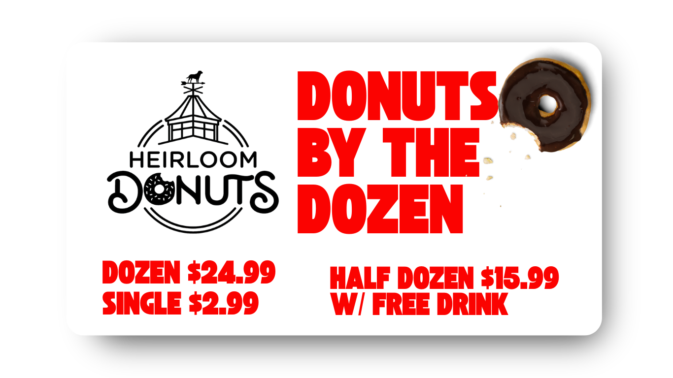 Advertisement for Heirloom Donuts offering a dozen donuts for $24.99, half dozen for $15.99 with a free drink, and single donuts for $2.99. The ad features a logo of a barn-like structure with a weather vane and a donut with chocolate glaze. The text is bold and red on a white background.