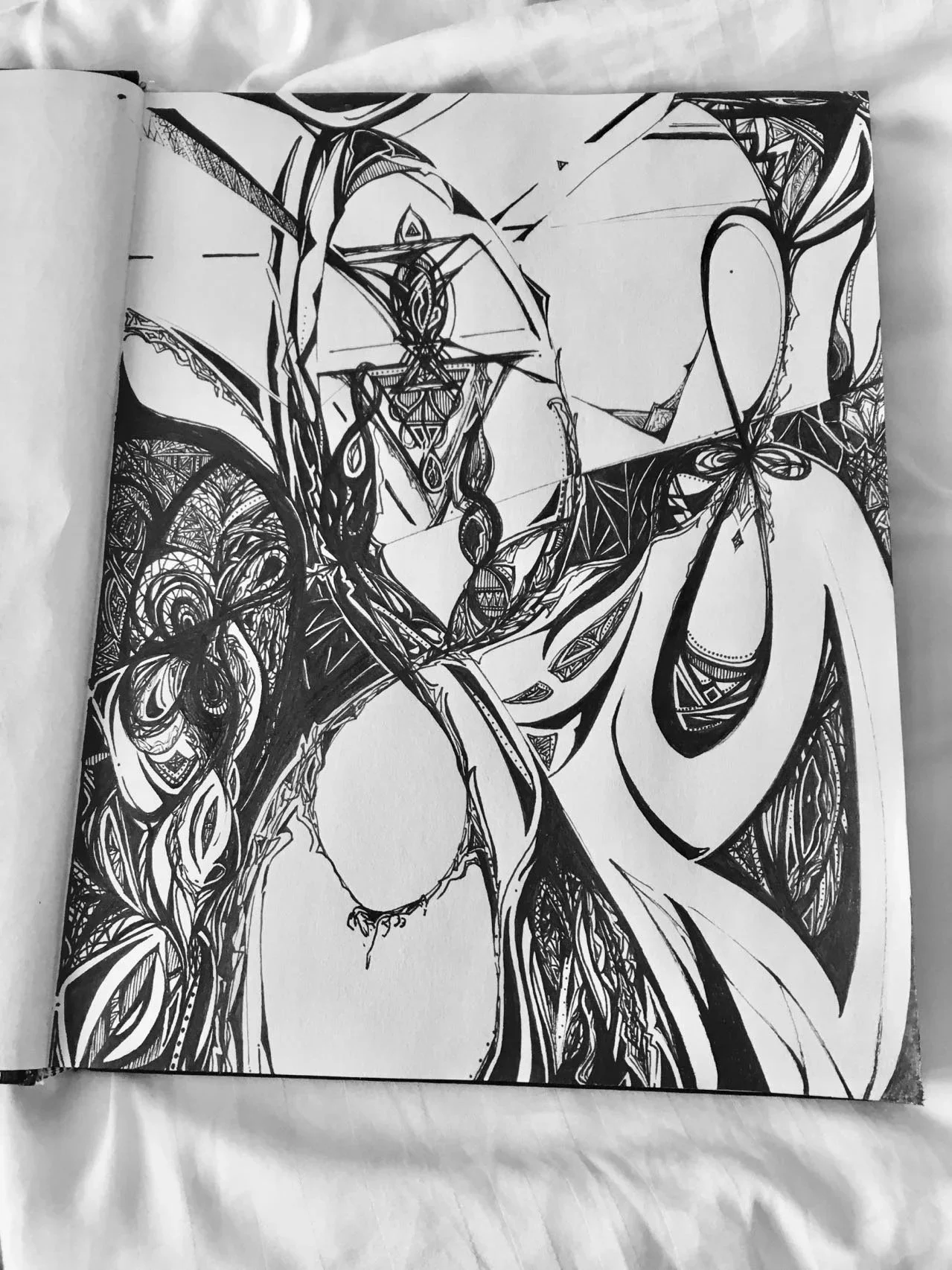 Black and white abstract ink drawing with intricate geometric patterns and swirling lines, likely depicting a stylized figure or object.