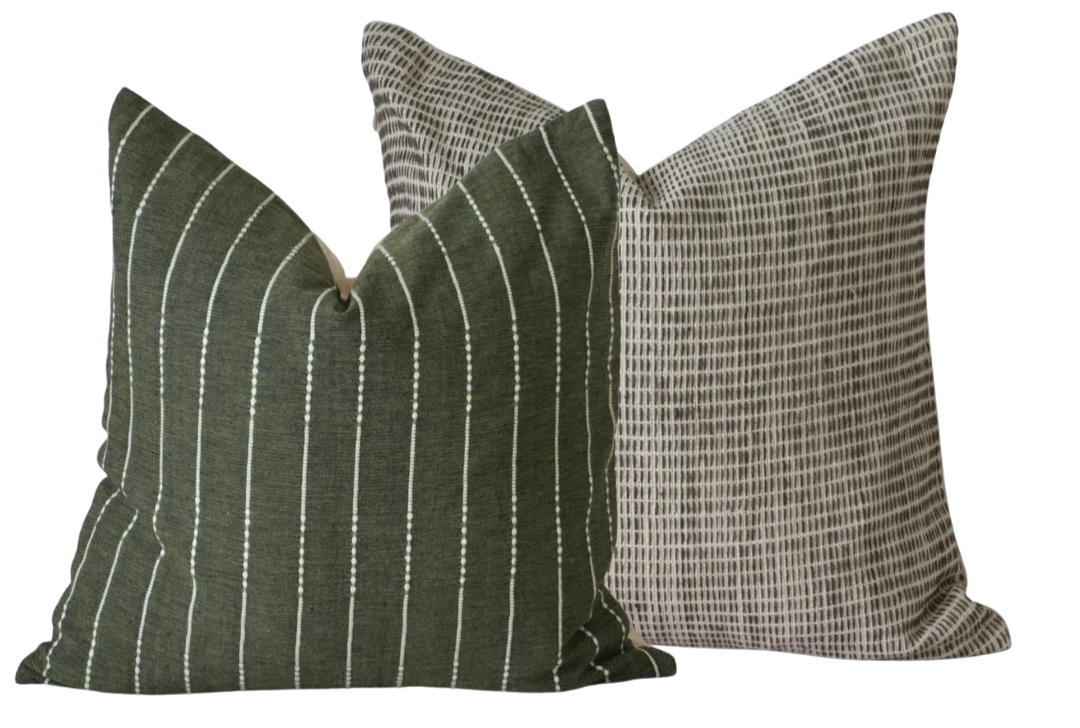 Two decorative throw pillows, one with green and white stripes and the other with a black and white grid pattern.