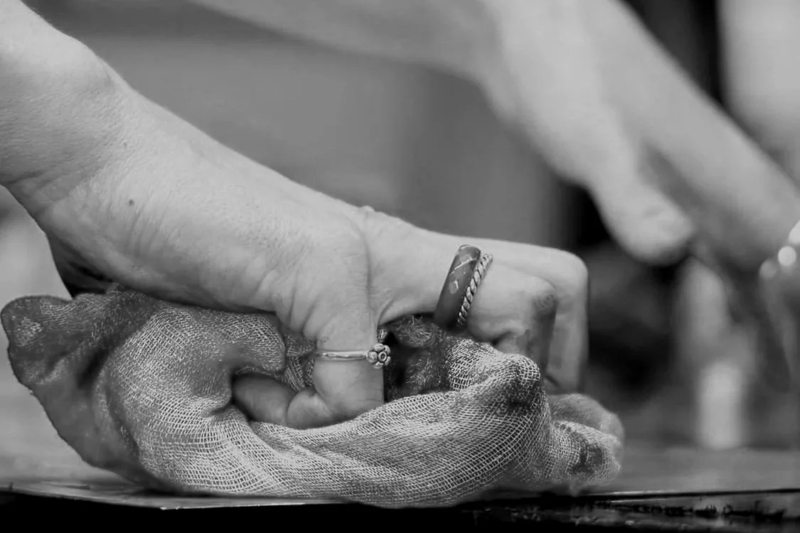 back and white image of the artists hands, close up, creating their art