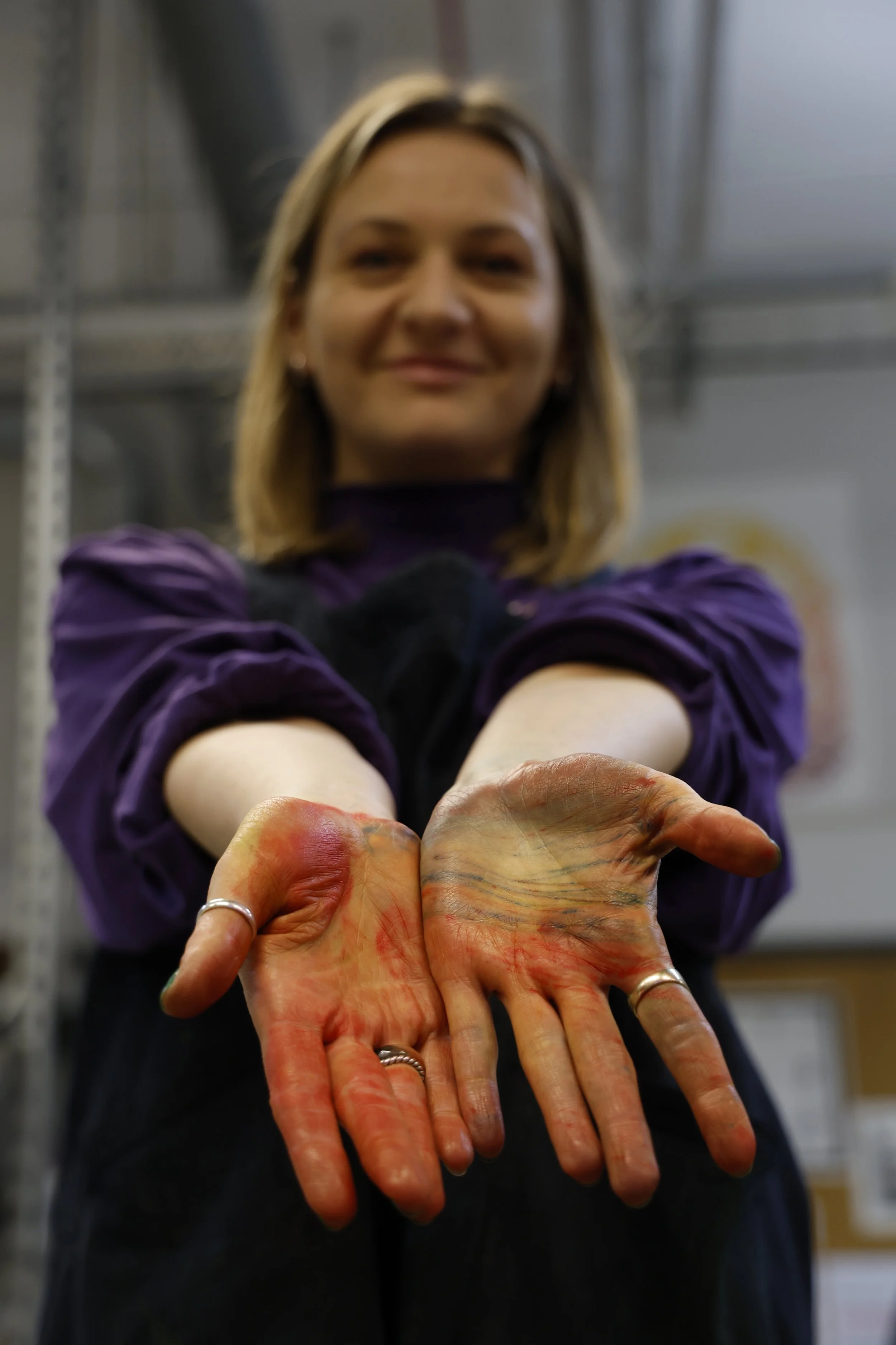 A picture of the artists paintand ink covered hands as a welcoming hello