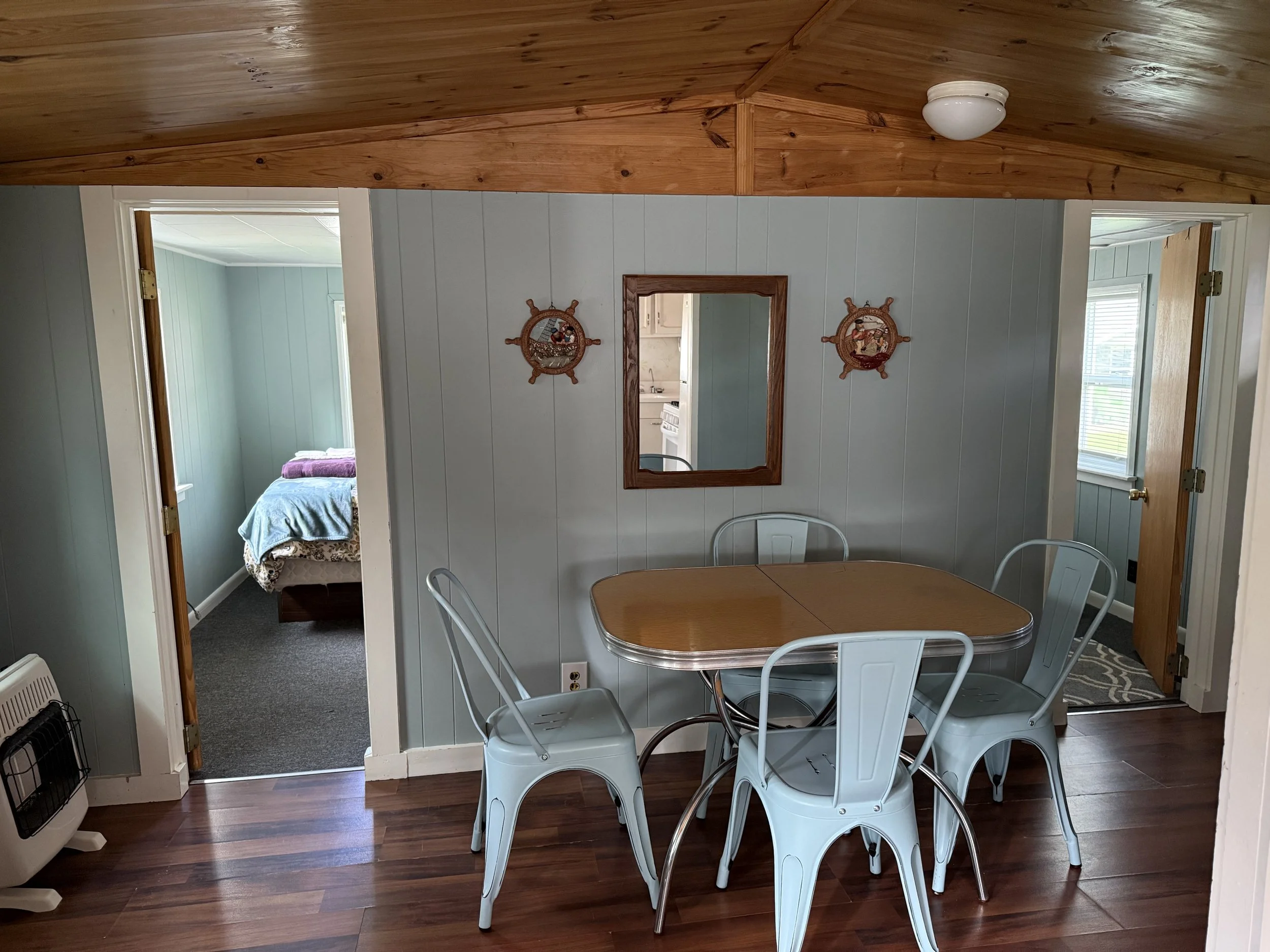 2 bedroom with kitchen and dining room and a nautical-themed wall decorations. Brookside Lake Cottages Duck Lake, Grawn, MI