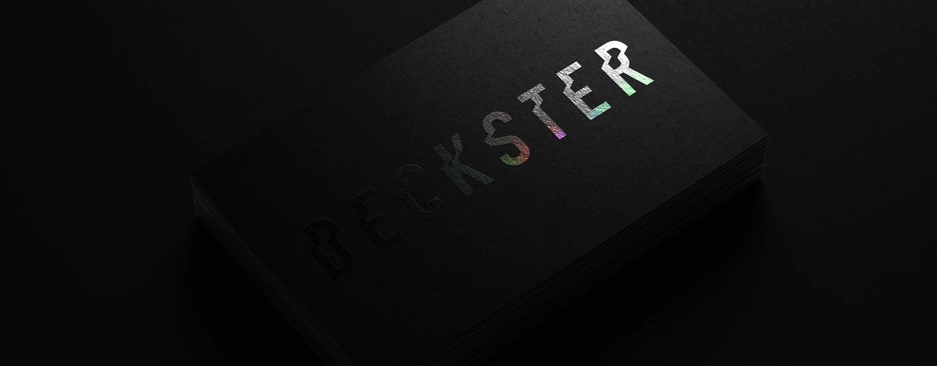 Black business card with holographic "BECKSTER" text on a dark background. Minimal techno logo.
