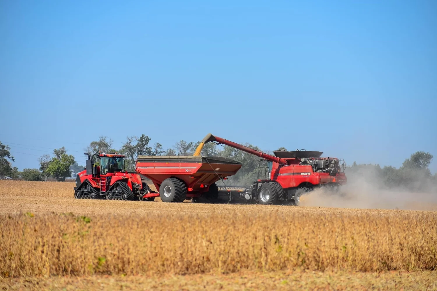 Case IH combine and Quadtrac unloading in the field