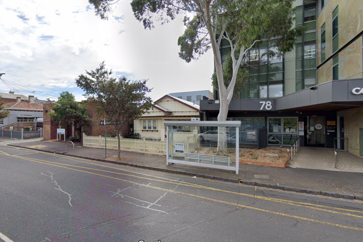 Street view showing modern building at 78 with trees and an older small house at 80 Pasley with a white picket fence.